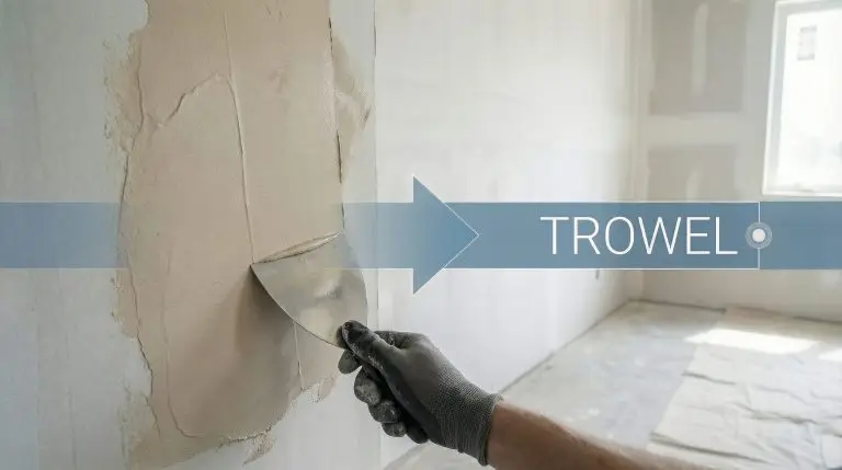 Highlighting the difference in roman clay vs limewash application, a painter uses a flexible putty knife to burnish thick clay paste onto a wall.