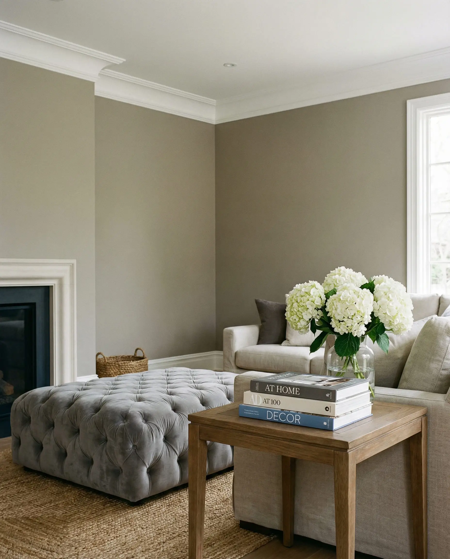 Classic transitional living room with warm grey walls and crisp white modern cove crown molding.