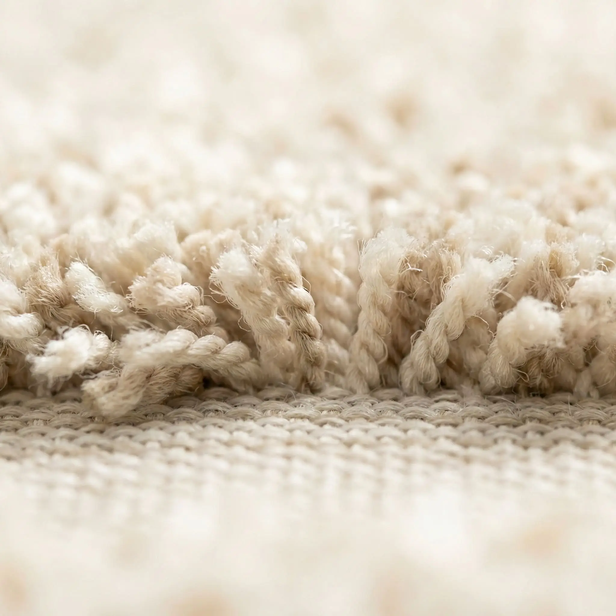 Extreme macro shot showing a cushioned, plush tufted pile securely attached to a flat washable backing.
