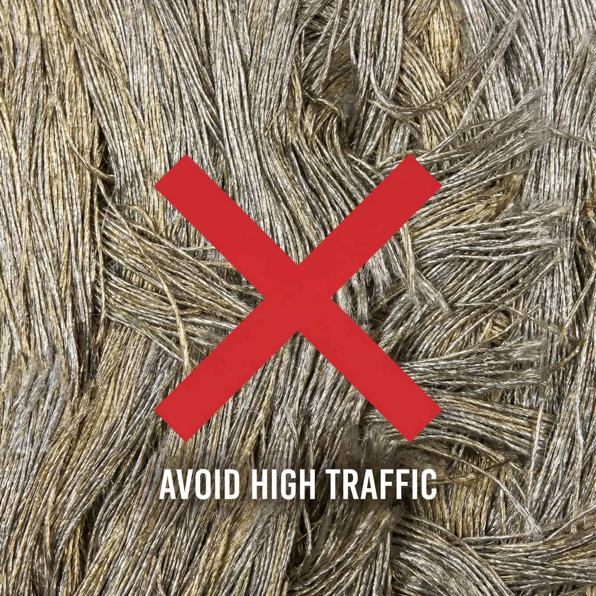 A delicate, flattened viscose rug with a bold red X graphic overlaid, warning against its use in busy homes.