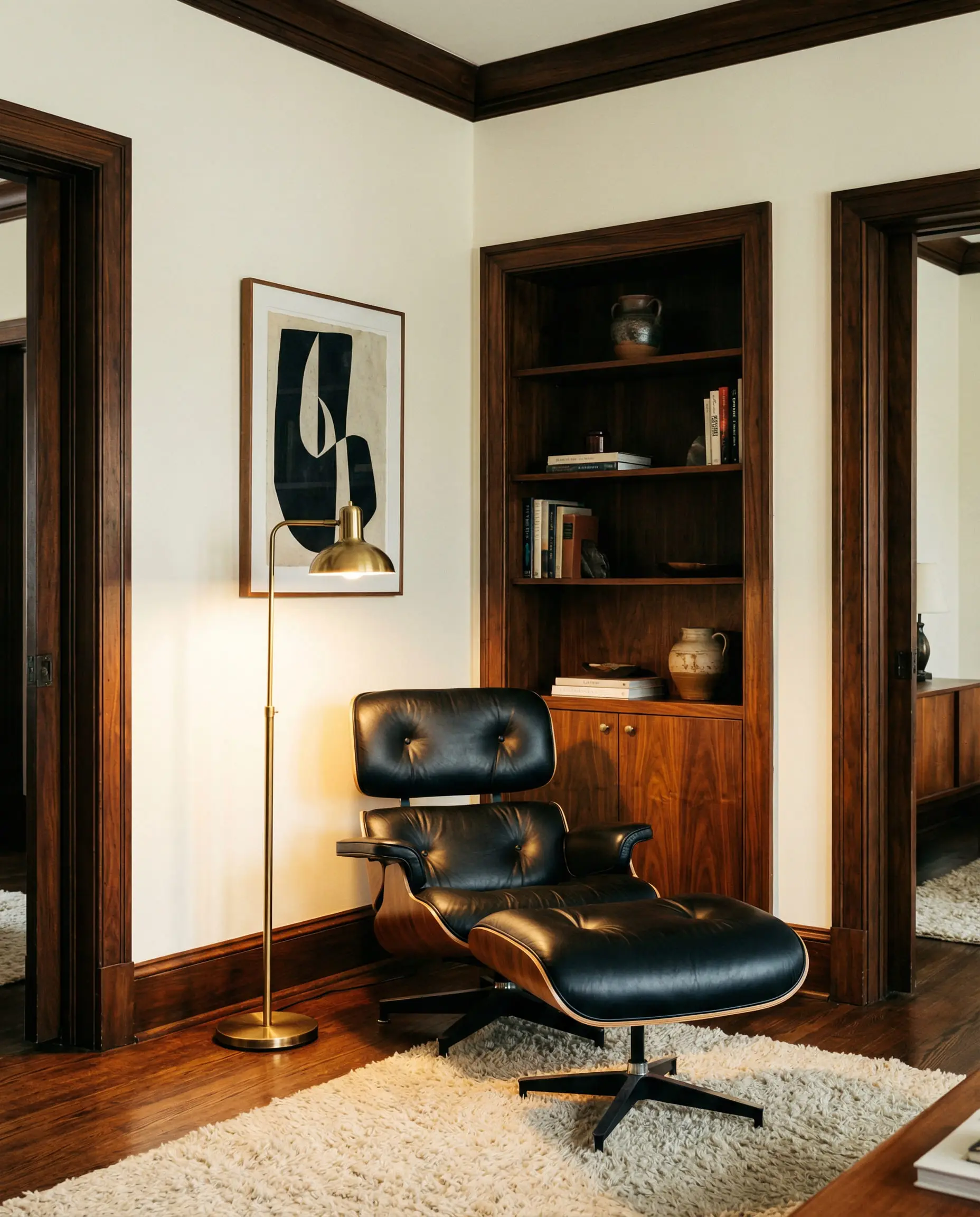 Mid-century modern living room with dark walnut trim and Eames chair against soft vanilla white walls.