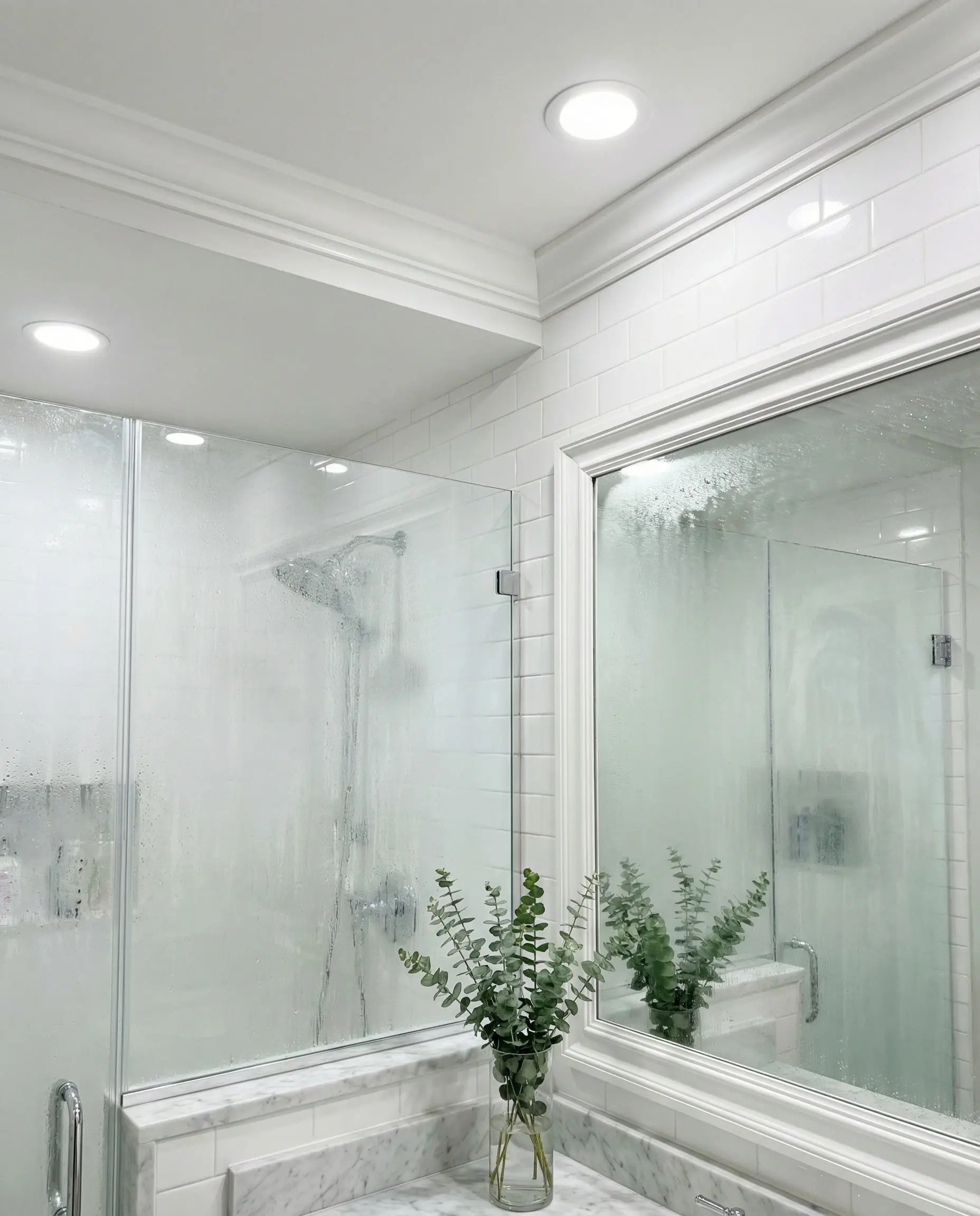 Modern bathroom vanity featuring moisture-resistant white PVC crown molding installed above a mirror and tile wall.