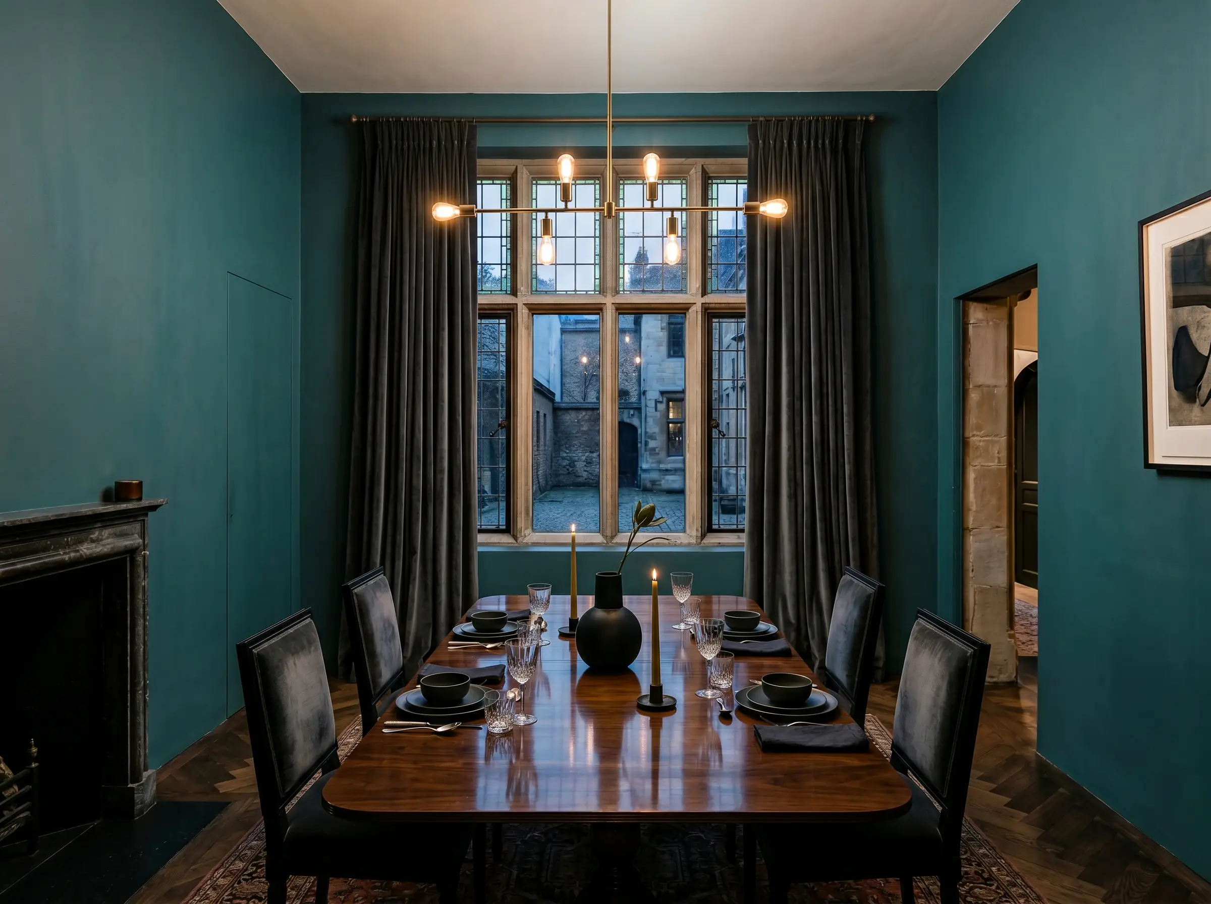 Dark charcoal mohair velvet window treatments and a reflective wood table sit within an intimate dining enclave painted in Farrow & Ball Vardo (Hex #427f83).