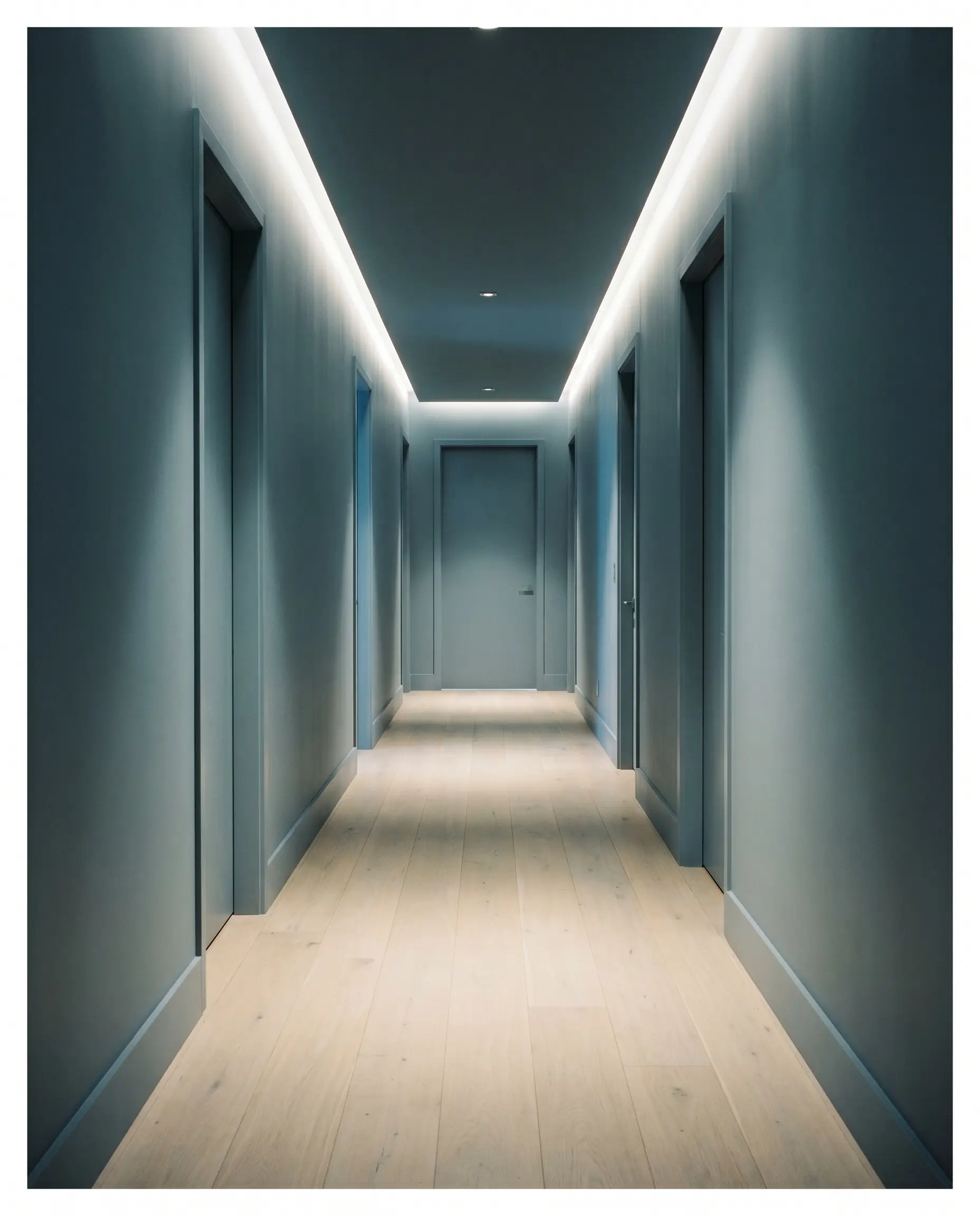 A long residential transition hallway features walls, trim, and interior doors entirely color-drenched in Dulux Mellow Flow (Hex #95A7B4) above bleached oak flooring.