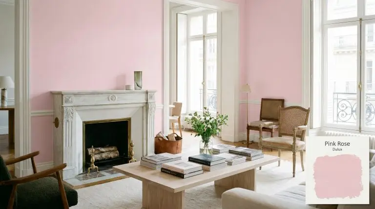 A luxurious Parisian dressing lounge features walls painted in Dulux Pink Rose (Hex #f8dbe5), a bleached ash wood coffee table, and a Carrara marble fireplace.