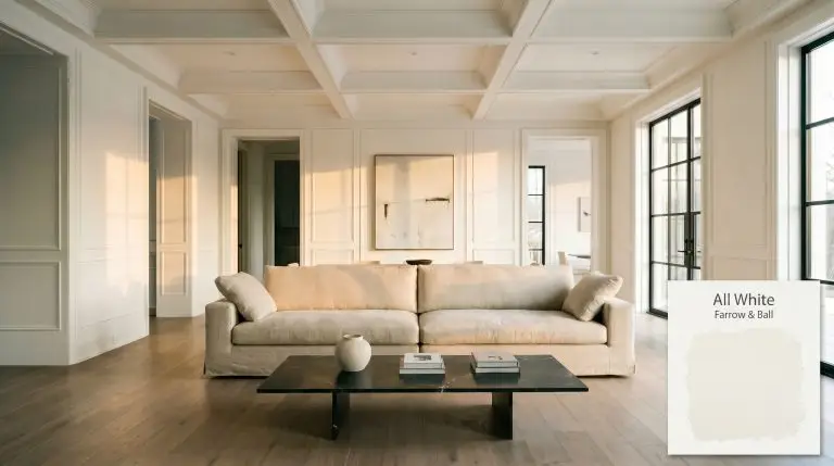 An expansive open-concept living space painted in Farrow & Ball All White (Hex #f6f6f2) features fumed European oak floors, a heavyweight Belgian linen sofa, and a leathered Nero Marquina marble coffee table.