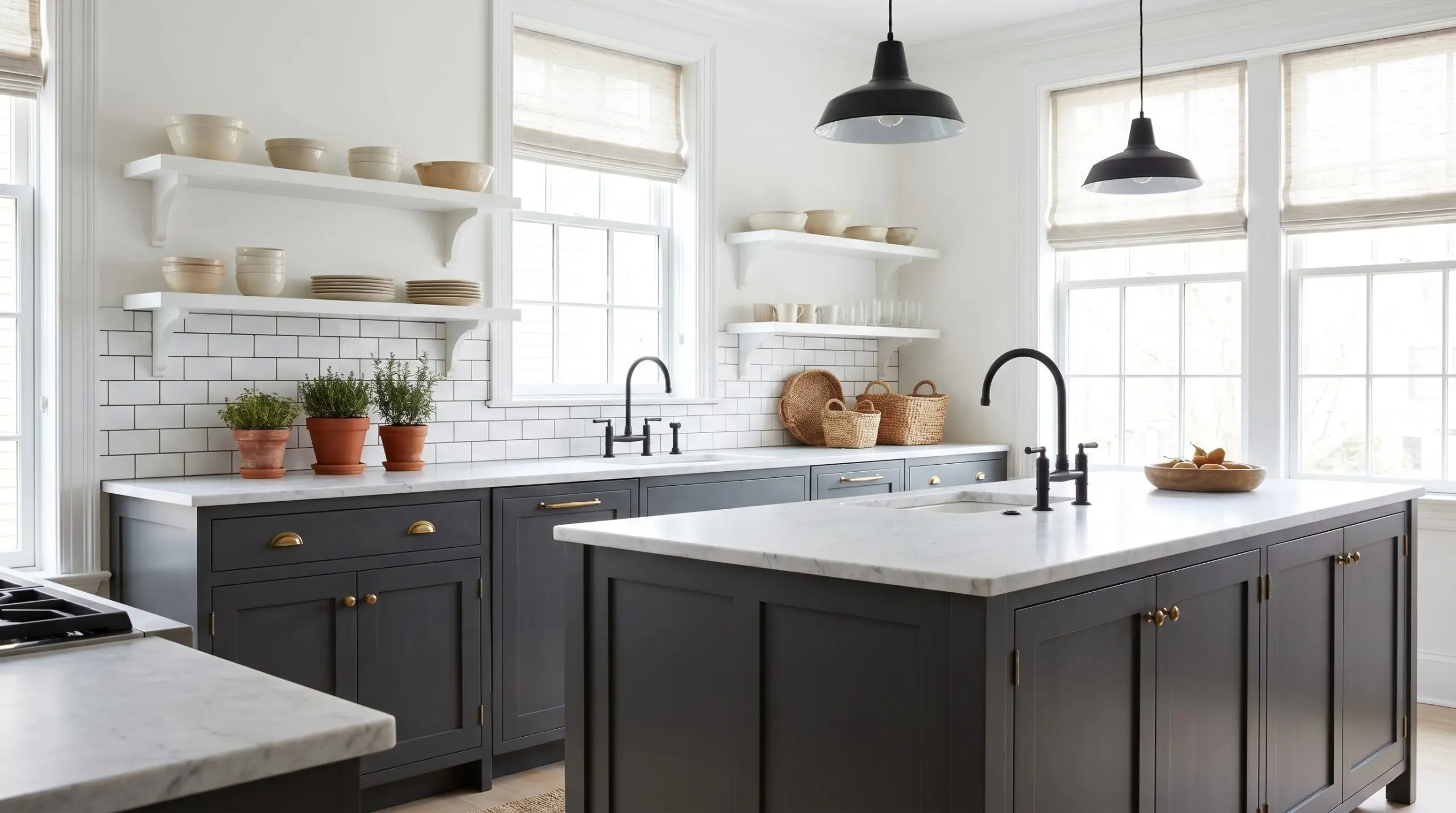 Dark charcoal lower cabinetry and a central island ground a classic kitchen featuring honed marble countertops, white subway tile, and matte black steel fixtures.