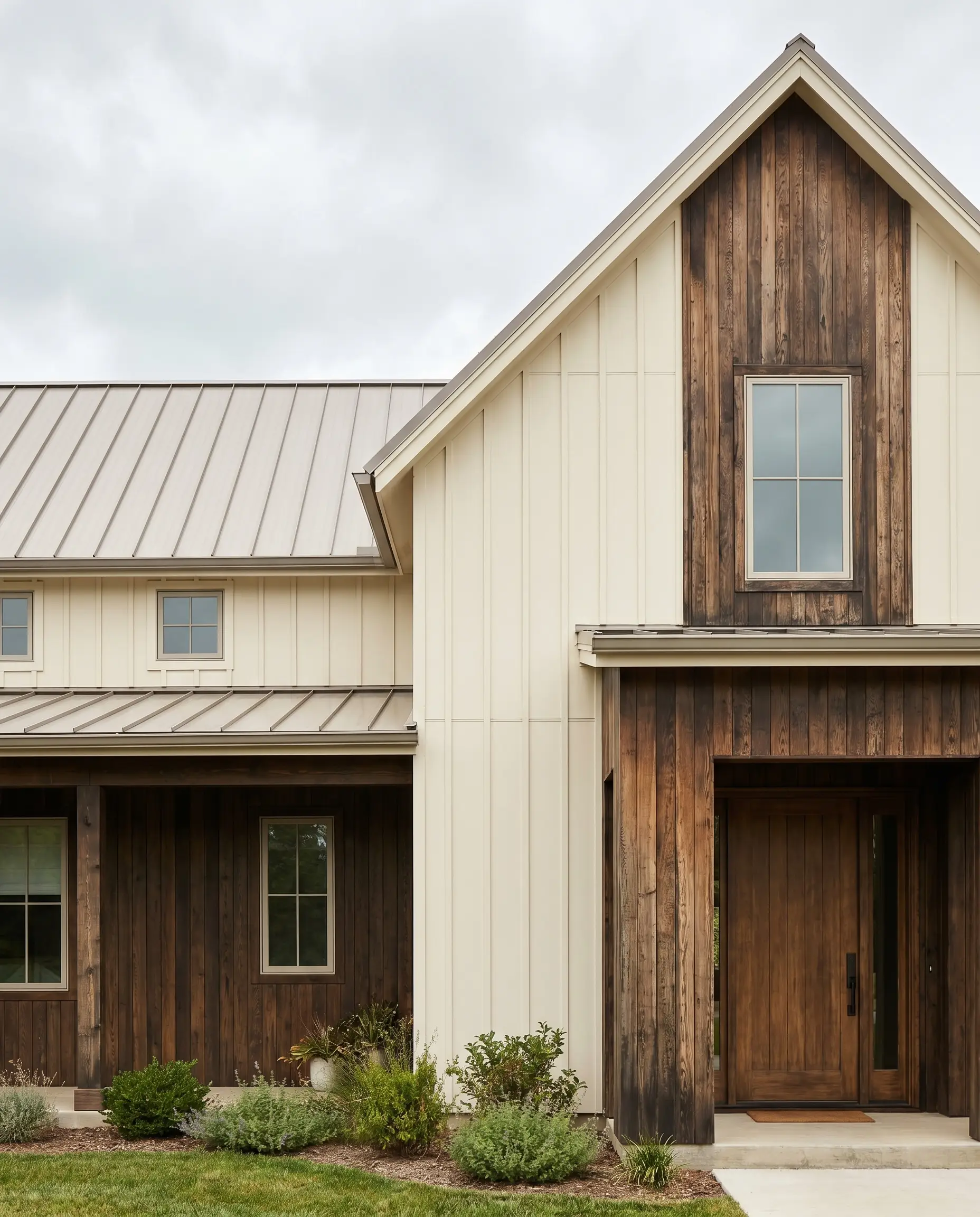 Warm Alabaster painted board and batten siding contrasts with sections of deep brown thermally modified ash wood cladding.