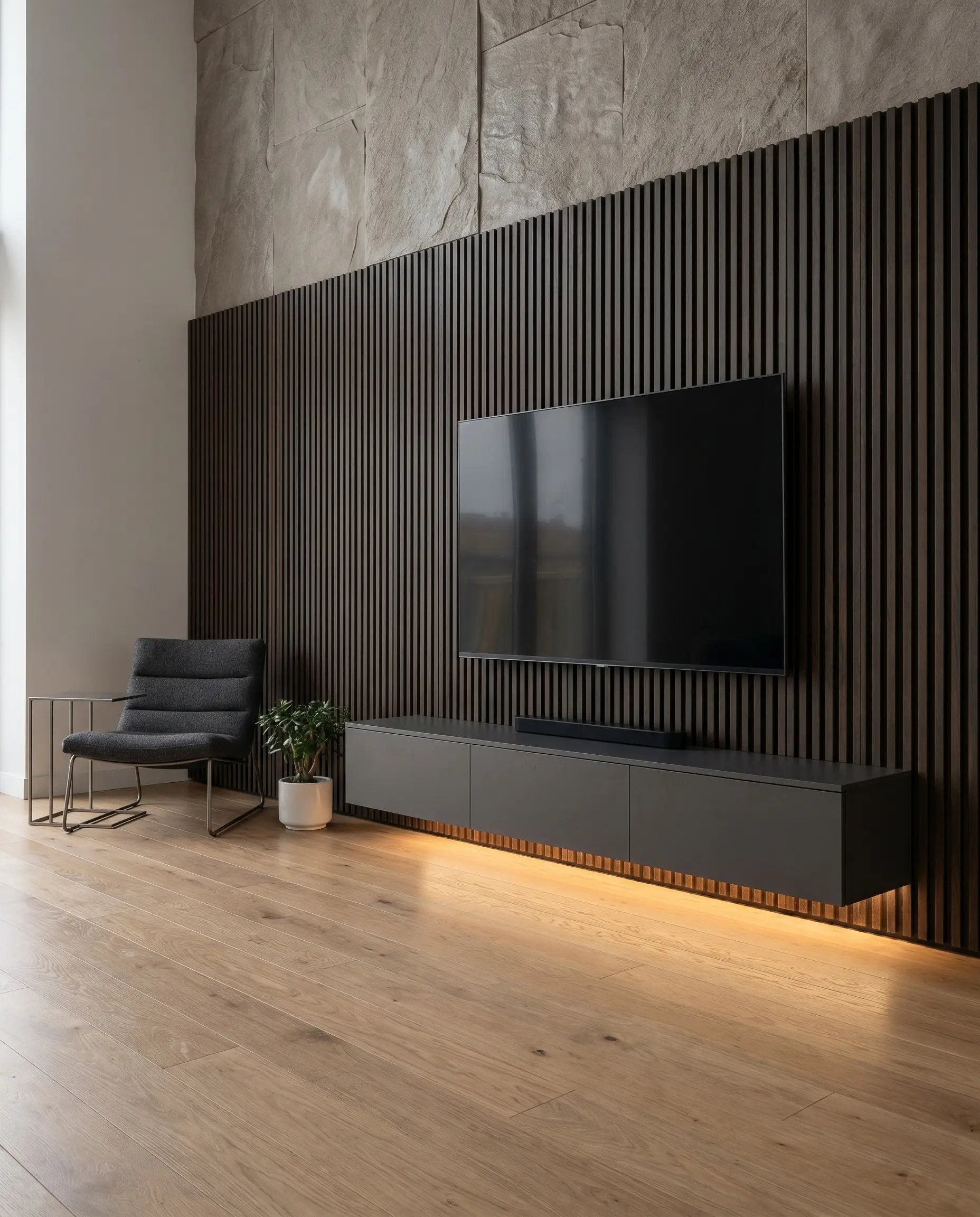 A sleek floating media console is suspended beneath a television on a heavy dark wood slat wall, illuminated by warm under-cabinet LED tracks.