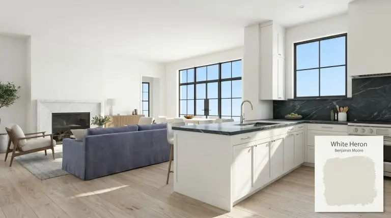 An open-concept living room and kitchen painted in Benjamin Moore White Heron (Hex #F0F1EA), featuring soapstone countertops, ash wood flooring, and south-facing windows.