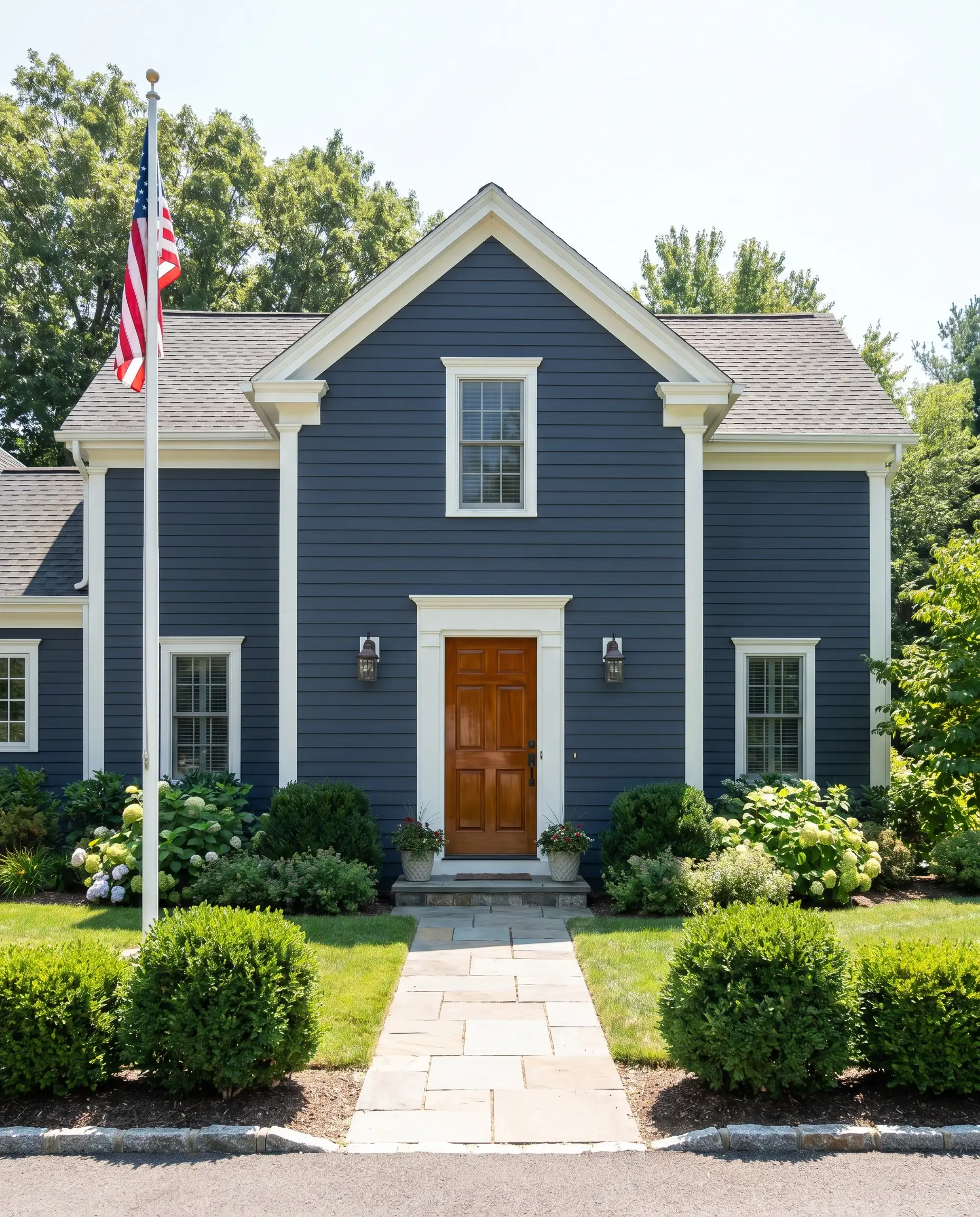 The best Benjamin Moore exterior paint colors include deep navy blue siding contrasted sharply by crisp white trim and a glossy natural mahogany door.