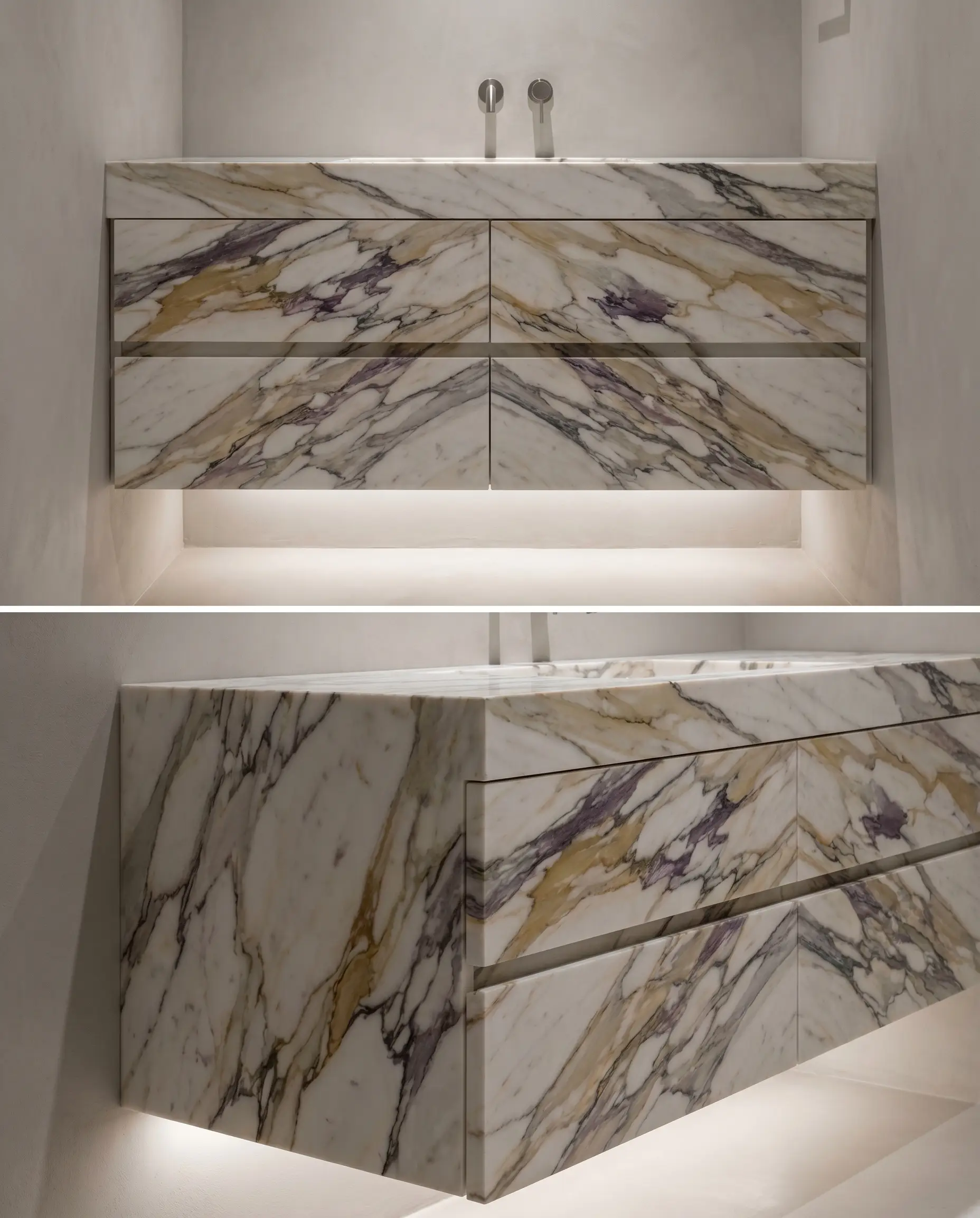 Sequentially cut calacatta corchia marble slabs create perfect bookmatching from the monolithic countertop down across the vertical push-to-open drawer fronts.
