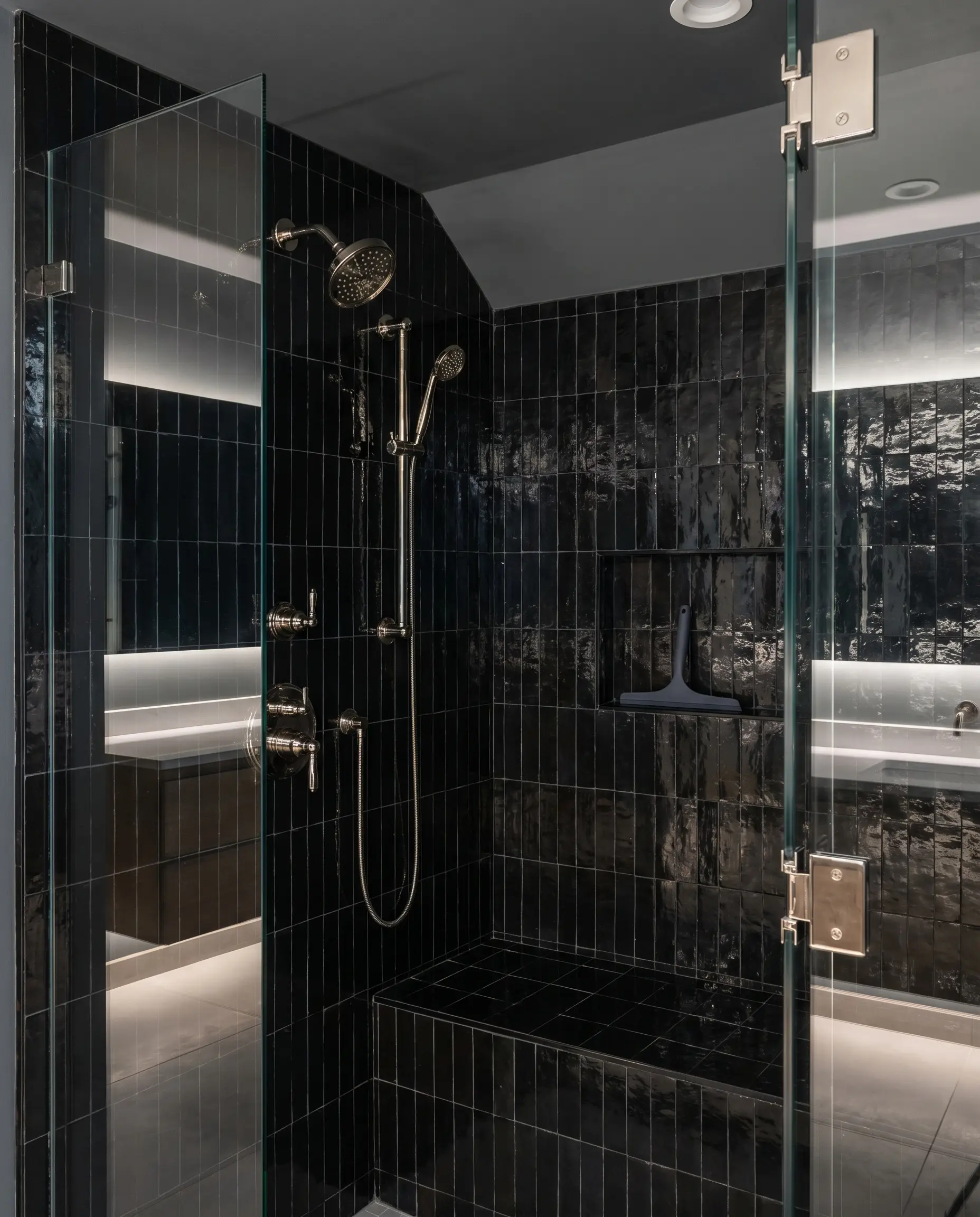 Carbon black zellige shower walls enclose an edgy transitional space featuring polished nickel hardware and a Sherwin-Williams Tricorn Black painted ceiling.