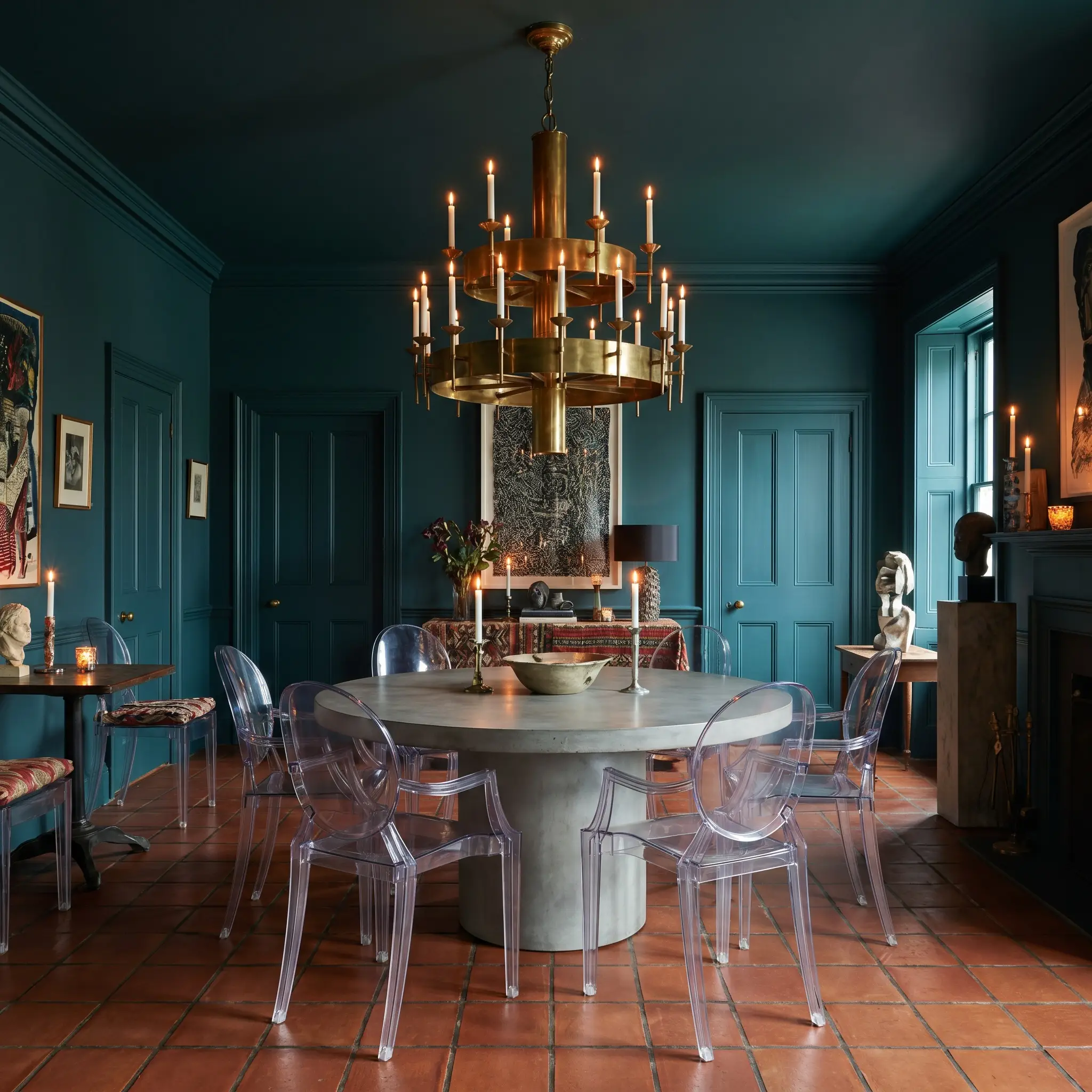 A postmodern dining room features seamless color drenching across walls and ceiling, highlighting a modern pedestal table, acrylic ghost chairs, and a massive brass chandelier.