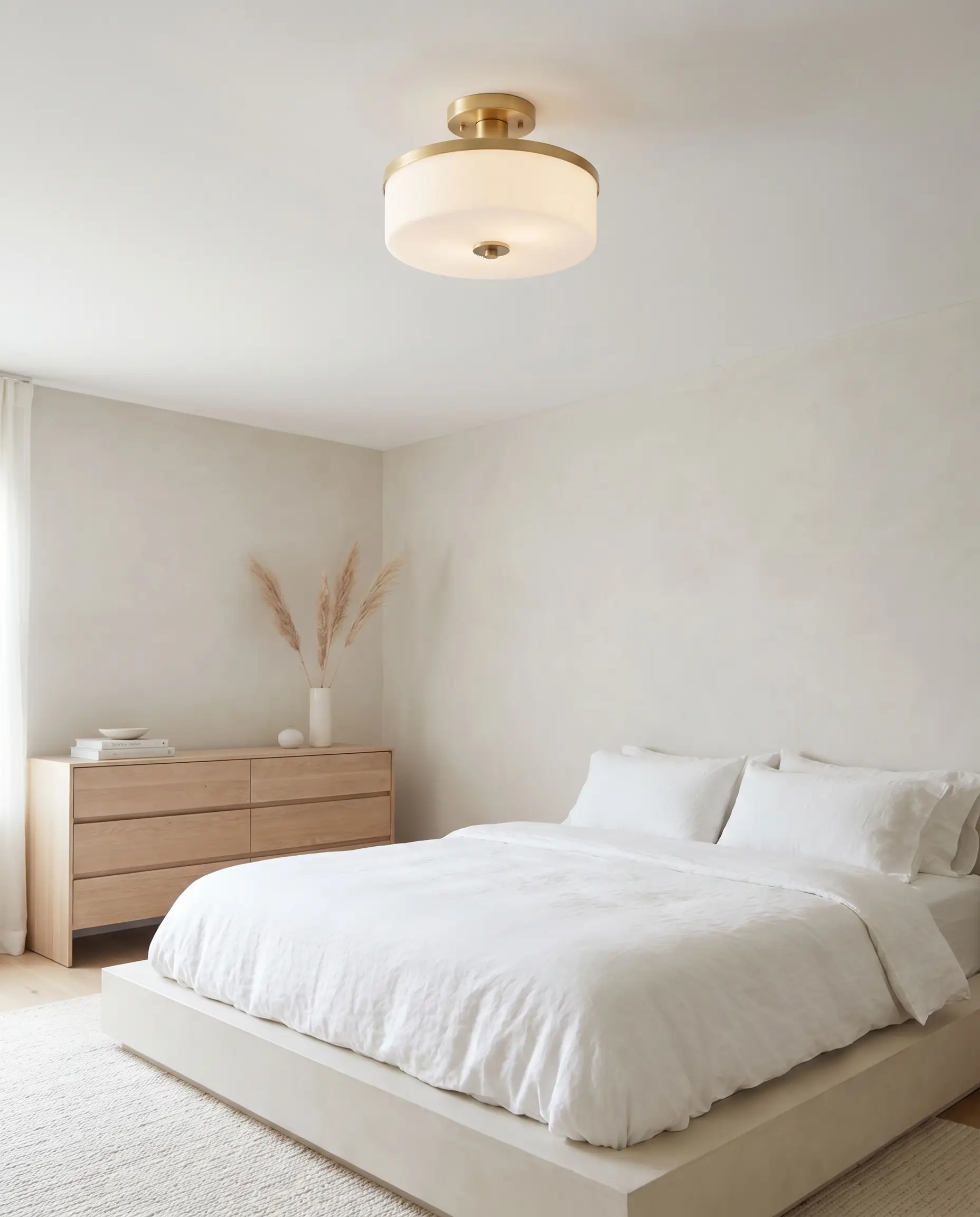 A contemporary semi-flush mount with a Benjamin Moore Chantilly Lace painted canopy plate provides statement lighting for low ceilings in a bedroom with an oak dresser.