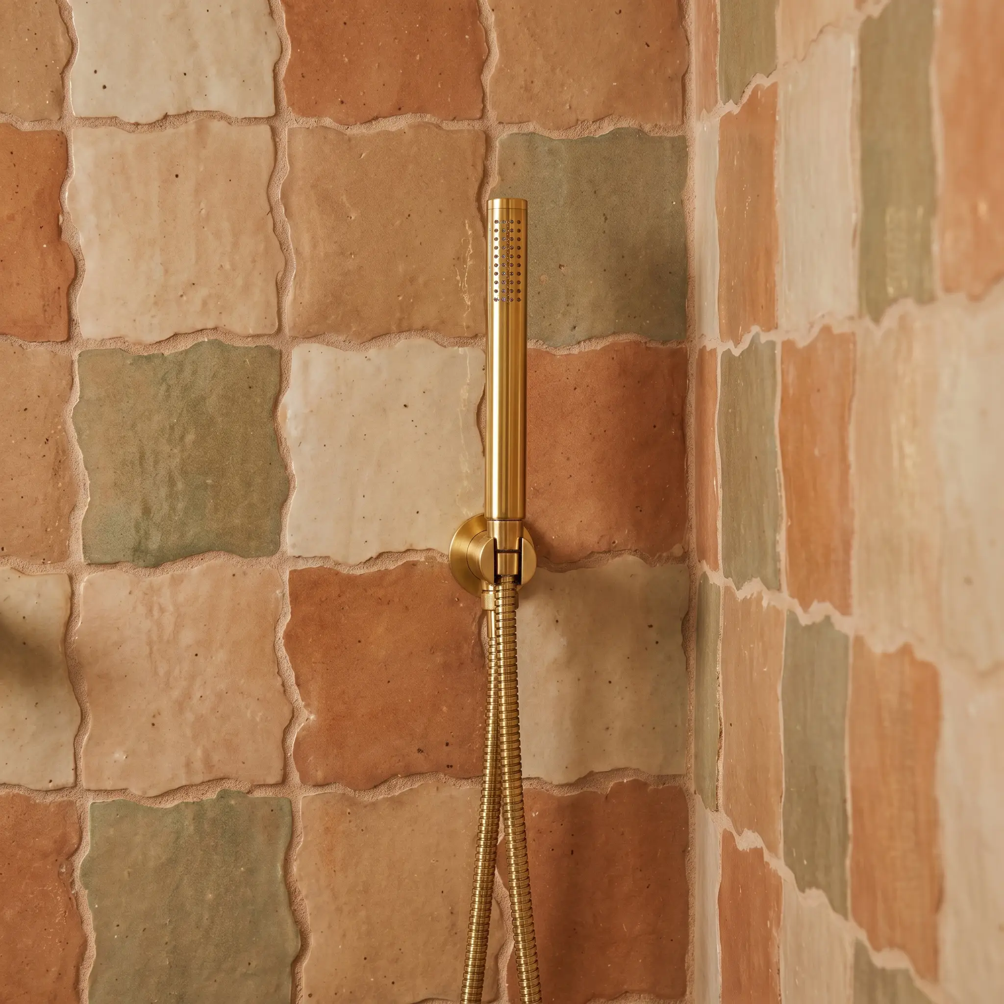Unrectified undulating tiles sit tightly together in a meticulous butt-joint installation where a fine-aggregate watery grout wash fills the natural micro-gaps.