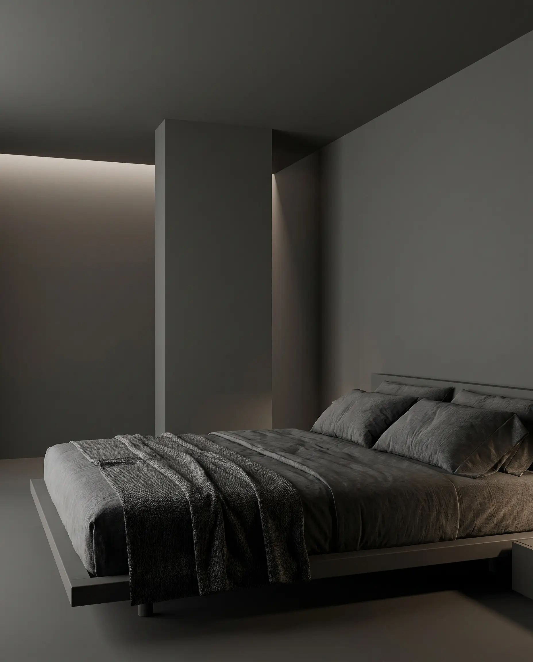 A central interior column, ceiling, and walls are color-drenched in dead flat Iron Mountain charcoal gray within a moody space featuring a low-slung minimalist bed.