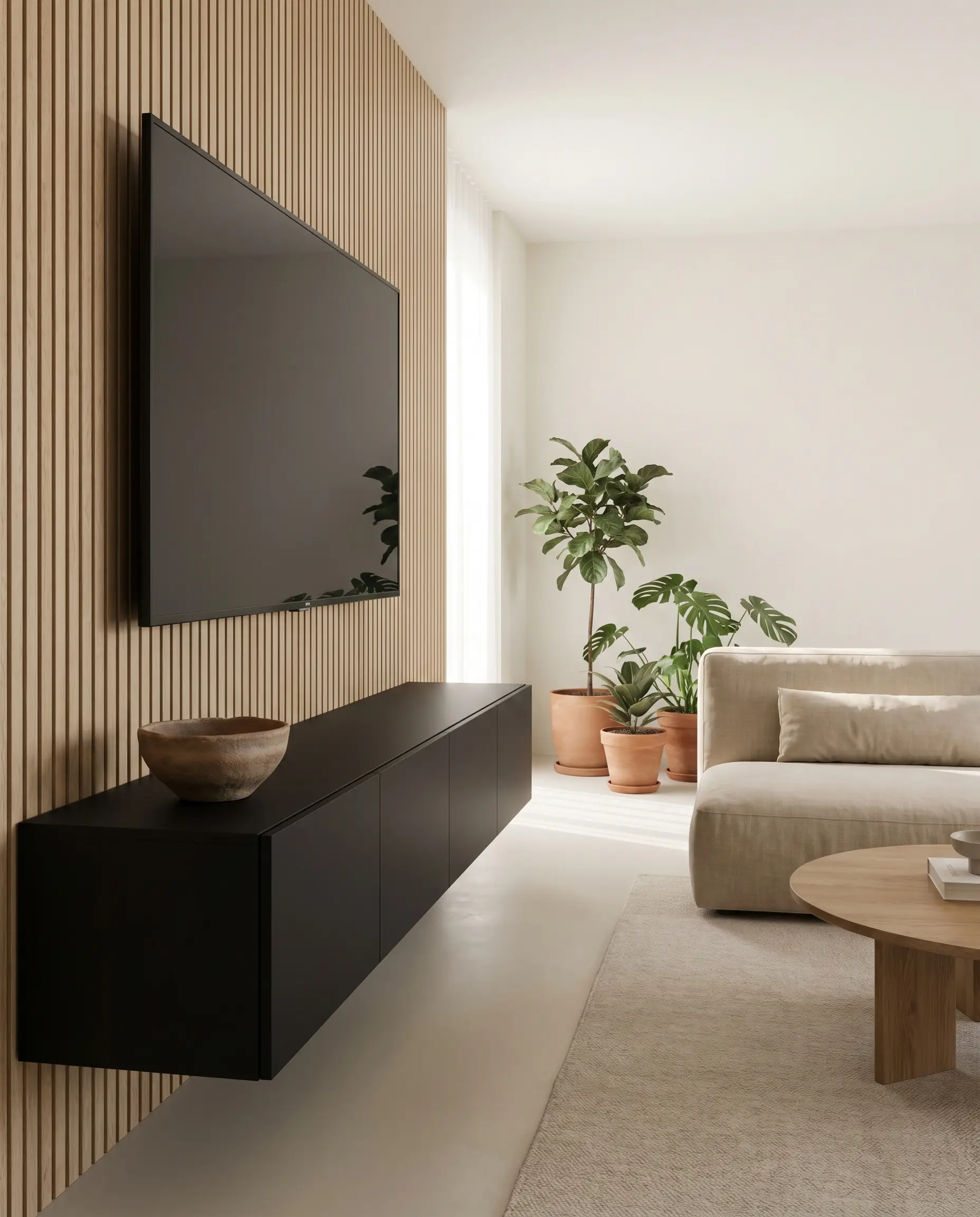 A highly textured clay bowl rests on one end of a completely bare matte black floating media console positioned beneath a pristine white oak slat wall.
