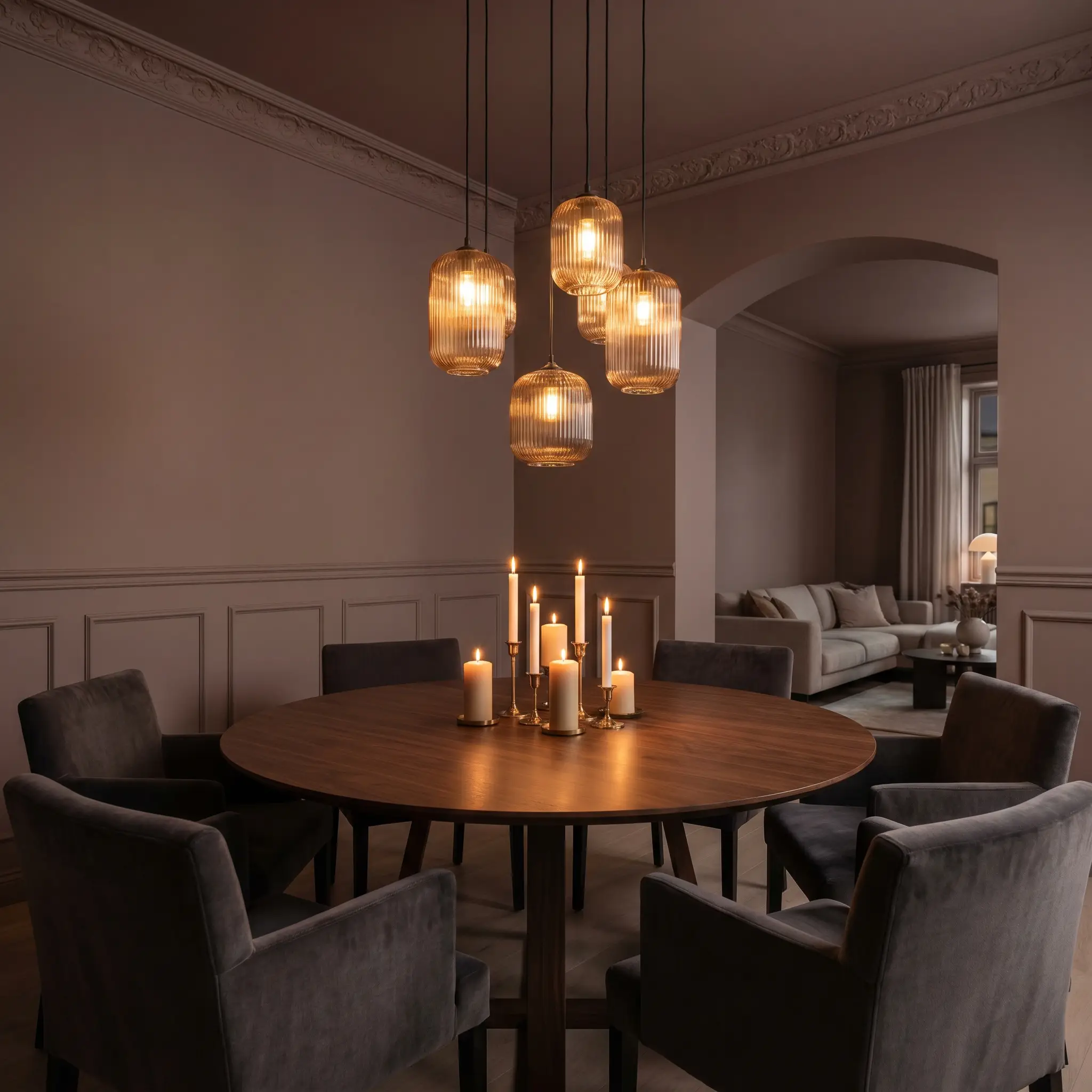 Plush mohair dining chairs surround a solid wood table in an intimate dining room enveloped by Farrow & Ball Broccoli Brown walls and crown molding.