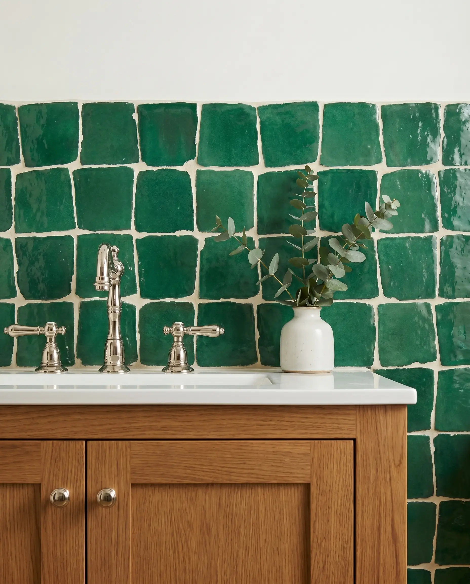 A warm oak vanity and classic polished nickel fixtures sit below a vibrant Moroccan clay wall installed with soft off-white alabaster grout.