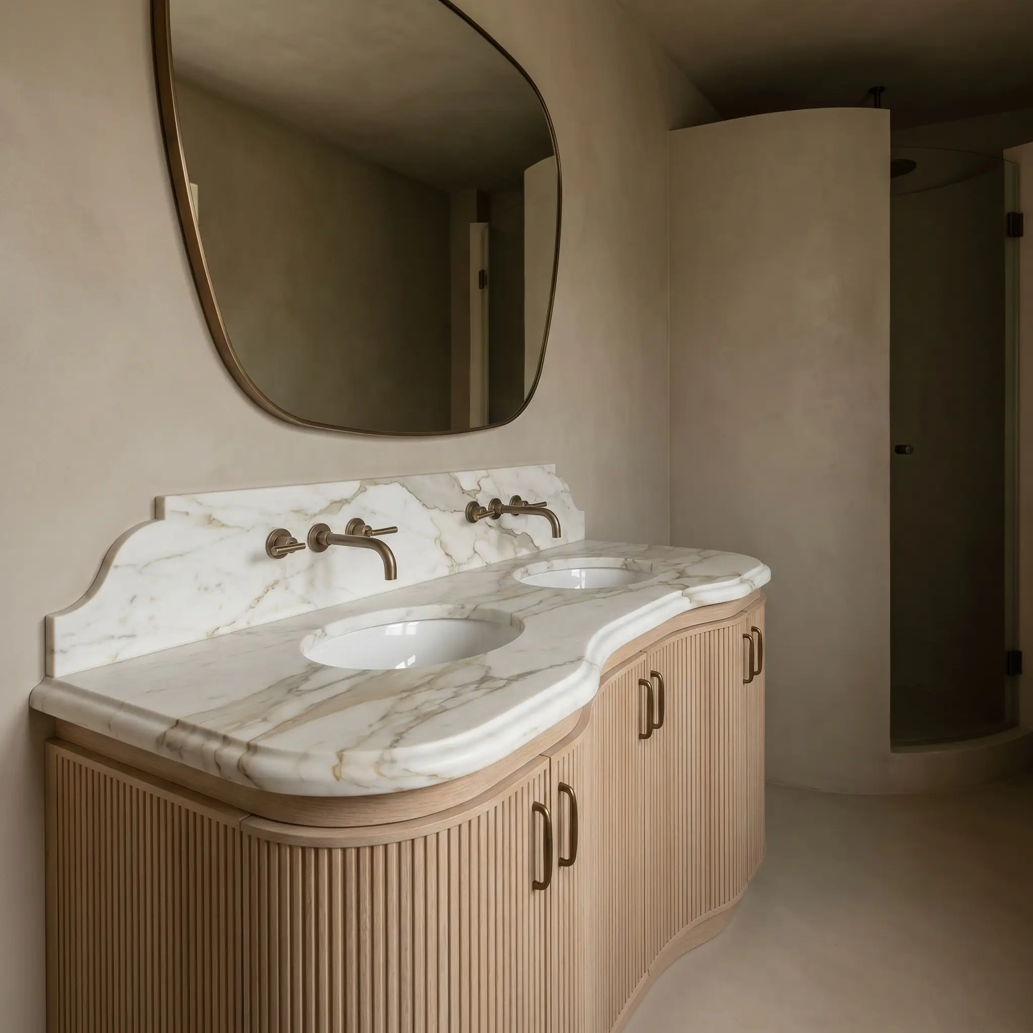 A custom scalloped calacatta vagli marble countertop with a half-bullnose profile rests on a curved rift-sawn white oak base with ribbed texture.