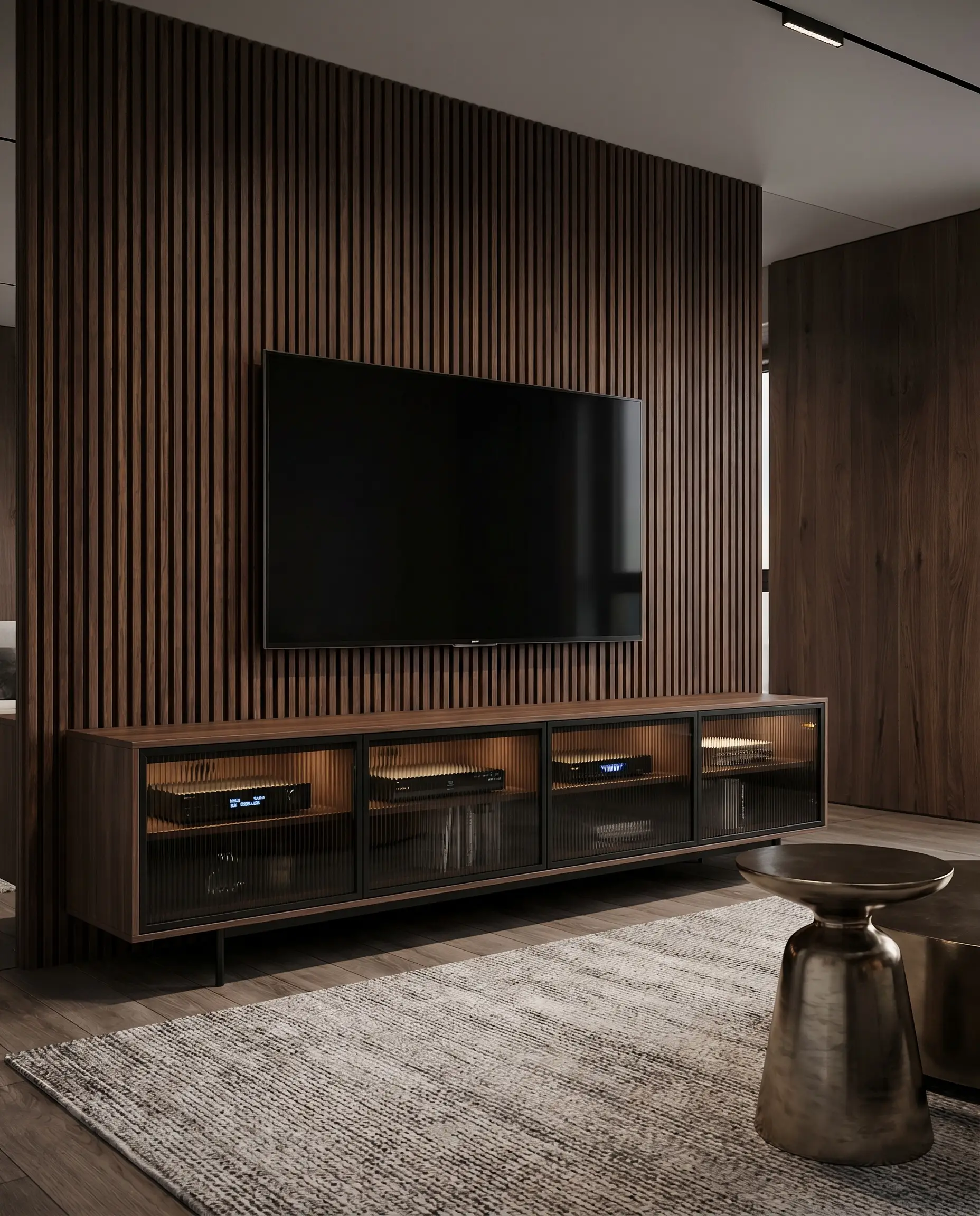 A sleek media console with ribbed smoked tempered glass doors and black anodized aluminum frames sits below a television on a saturated walnut slat wall.