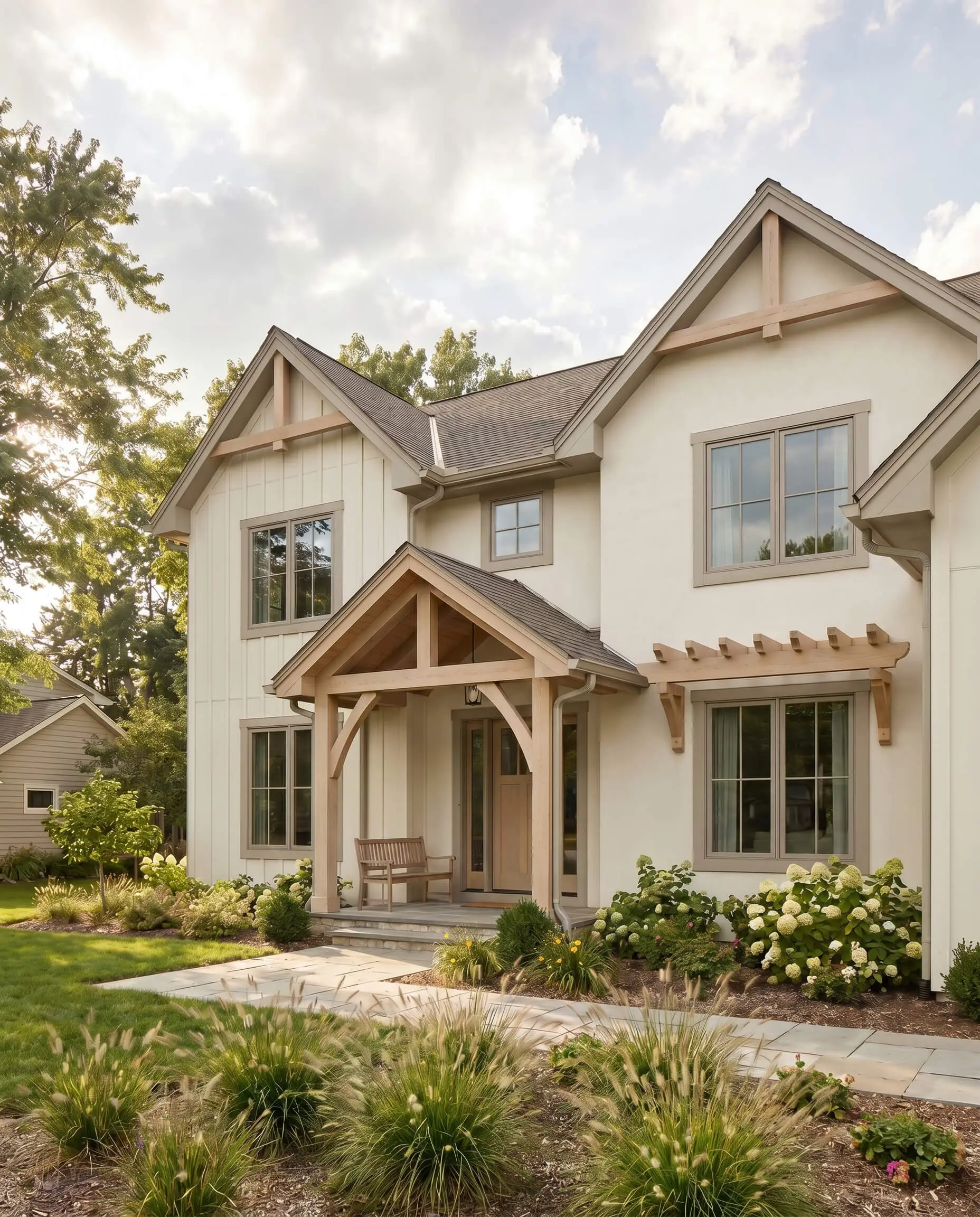 A creamy off-white exterior body features soft warm greige trim and pale oak wood architectural tones on a timber-framed modern farmhouse porch.