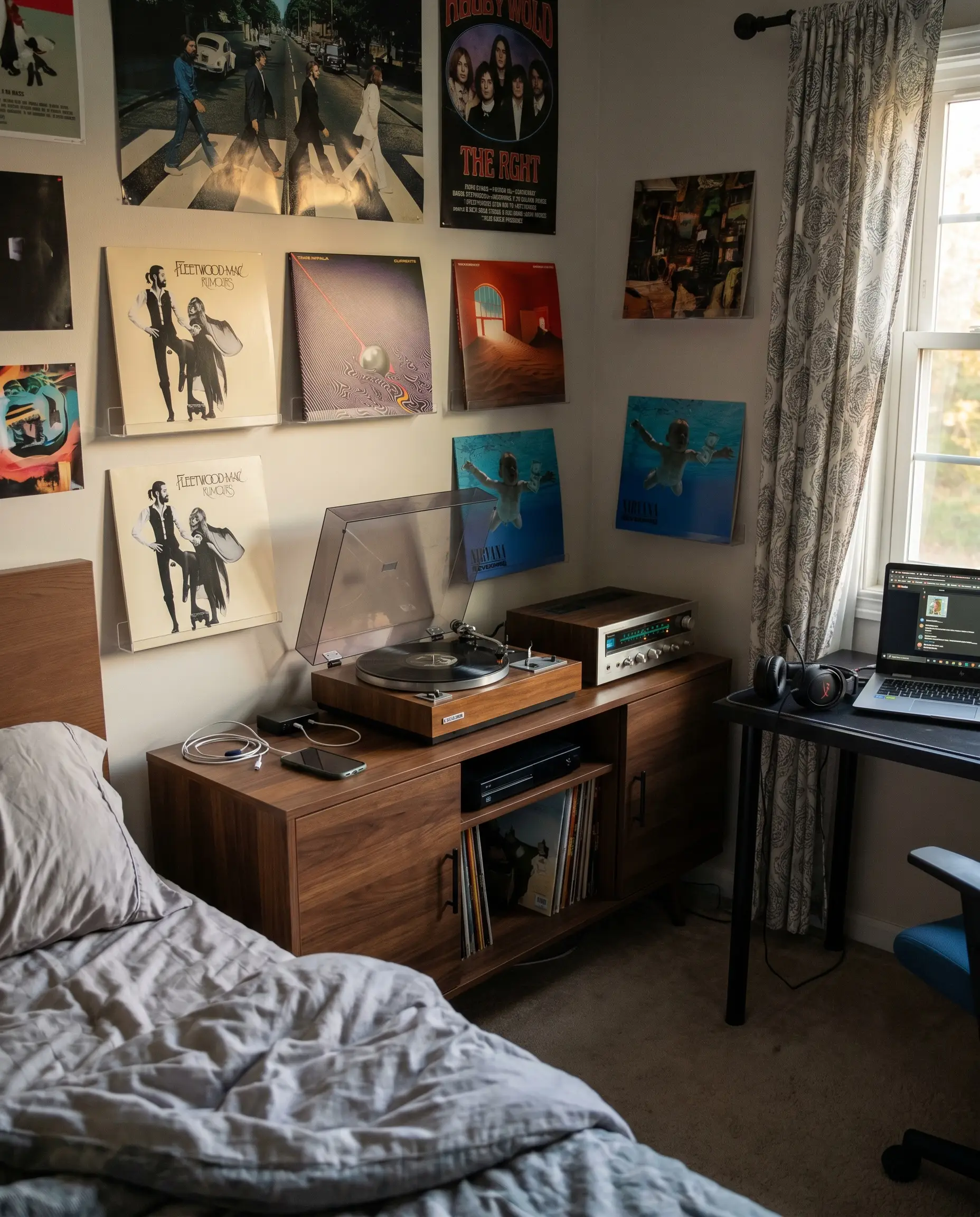 A walnut media console holds a vintage turntable, flanked by clear acrylic picture ledges displaying forward-facing vinyl record covers.