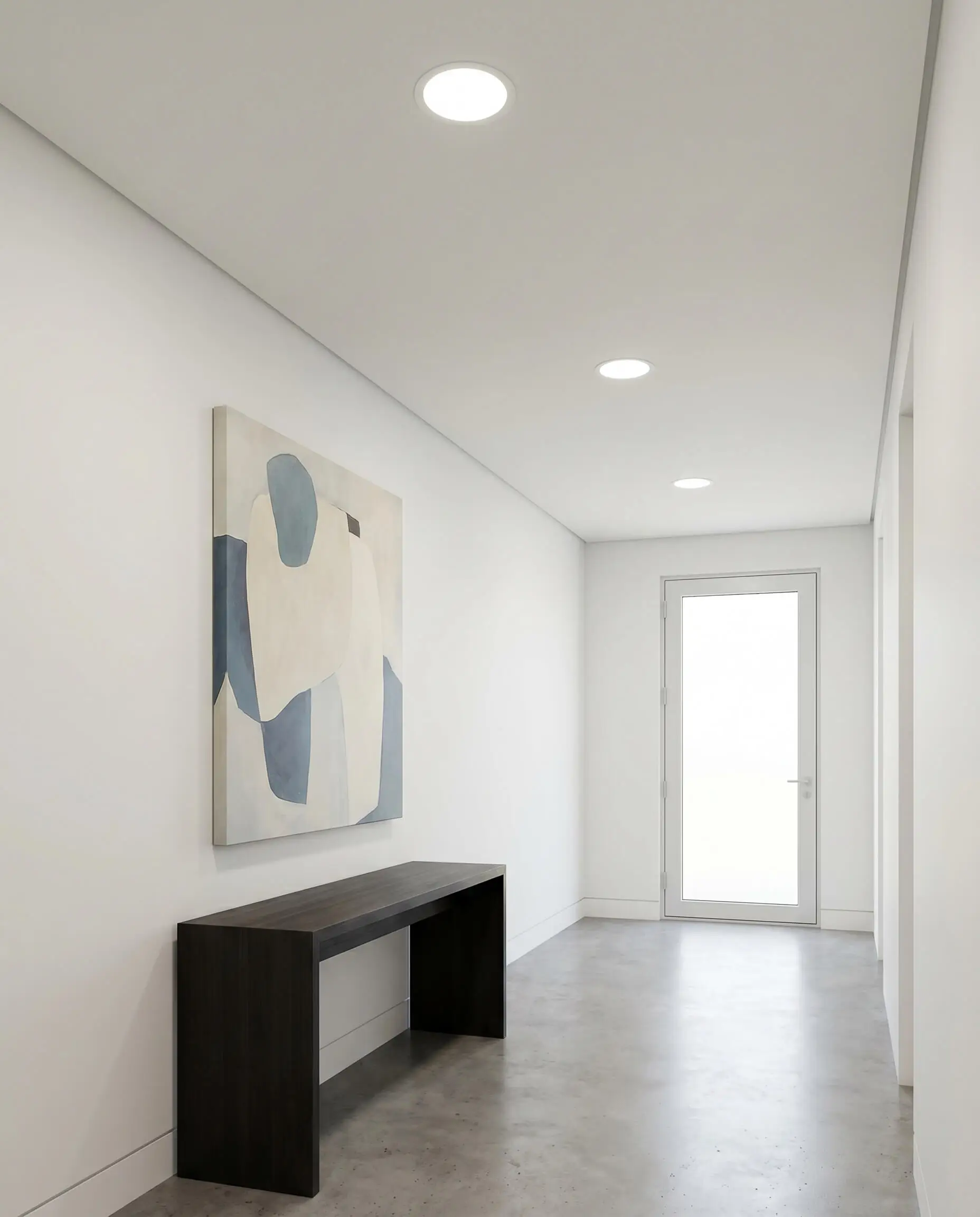 Trimless recessed downlights sink into a perfectly flat suspended ceiling of All White gypsum panels above an elegant residential hallway gallery displaying abstract art.