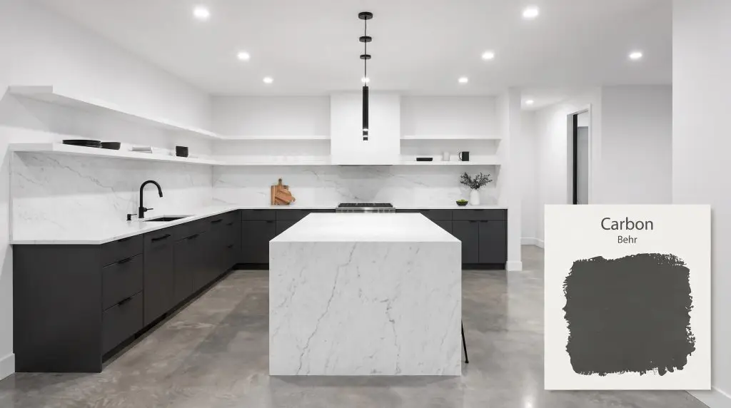 Stark white marble countertops and matte black fixtures contrast sharply against sleek lower kitchen cabinets painted in Behr Carbon (Hex #3d3e3e).