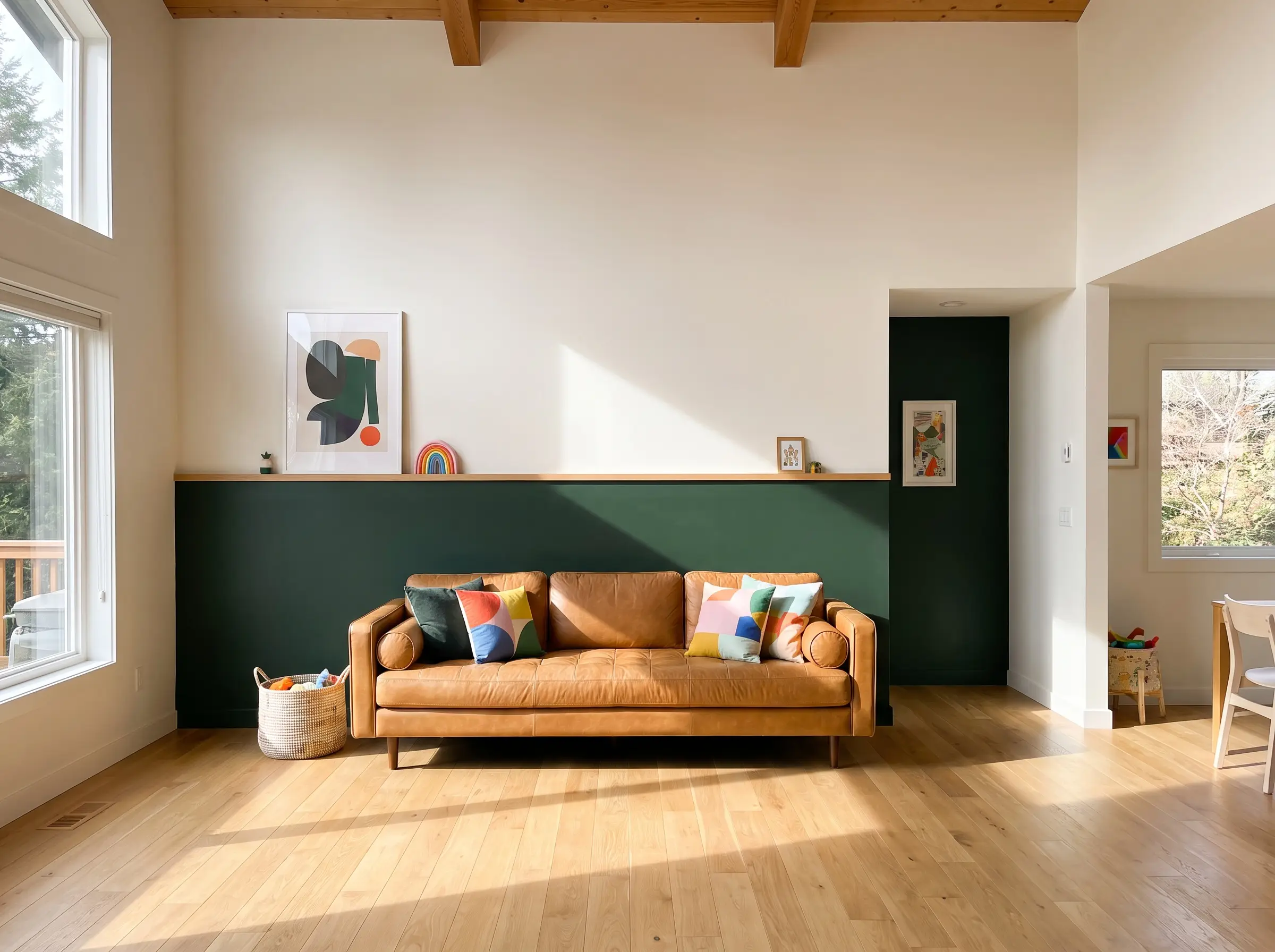 Essex green and alabaster paint are separated by an oak chair rail behind a heavy caramel leather sofa on light hardwood floors.