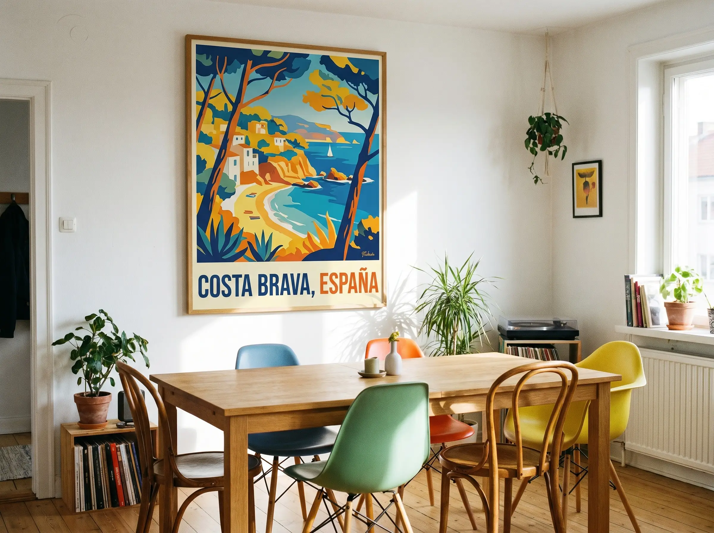 A saturated 1950s Mid-Century vintage European travel poster anchors a bright dining room featuring a standard wooden table and colorful modern chairs.