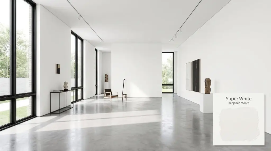 Sleek matte black window frames and polished concrete floors contrast sharply against a brilliant white gallery wall in BM Super White (Hex #F1F2EE).