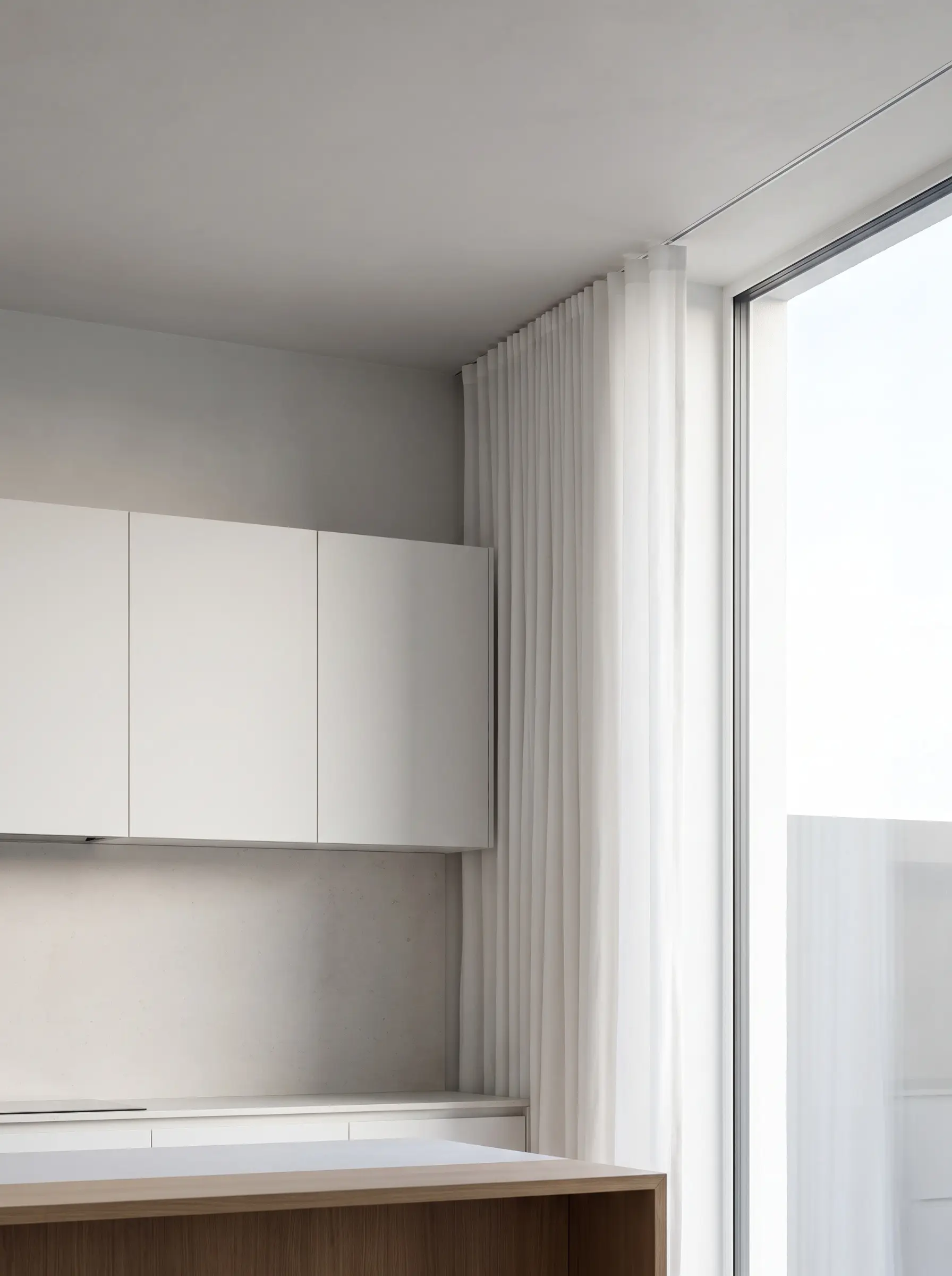 Pristine white ripple fold modern kitchen curtains drop seamlessly from an aluminum recessed track mortised into the drywall above smooth handleless upper cabinets.