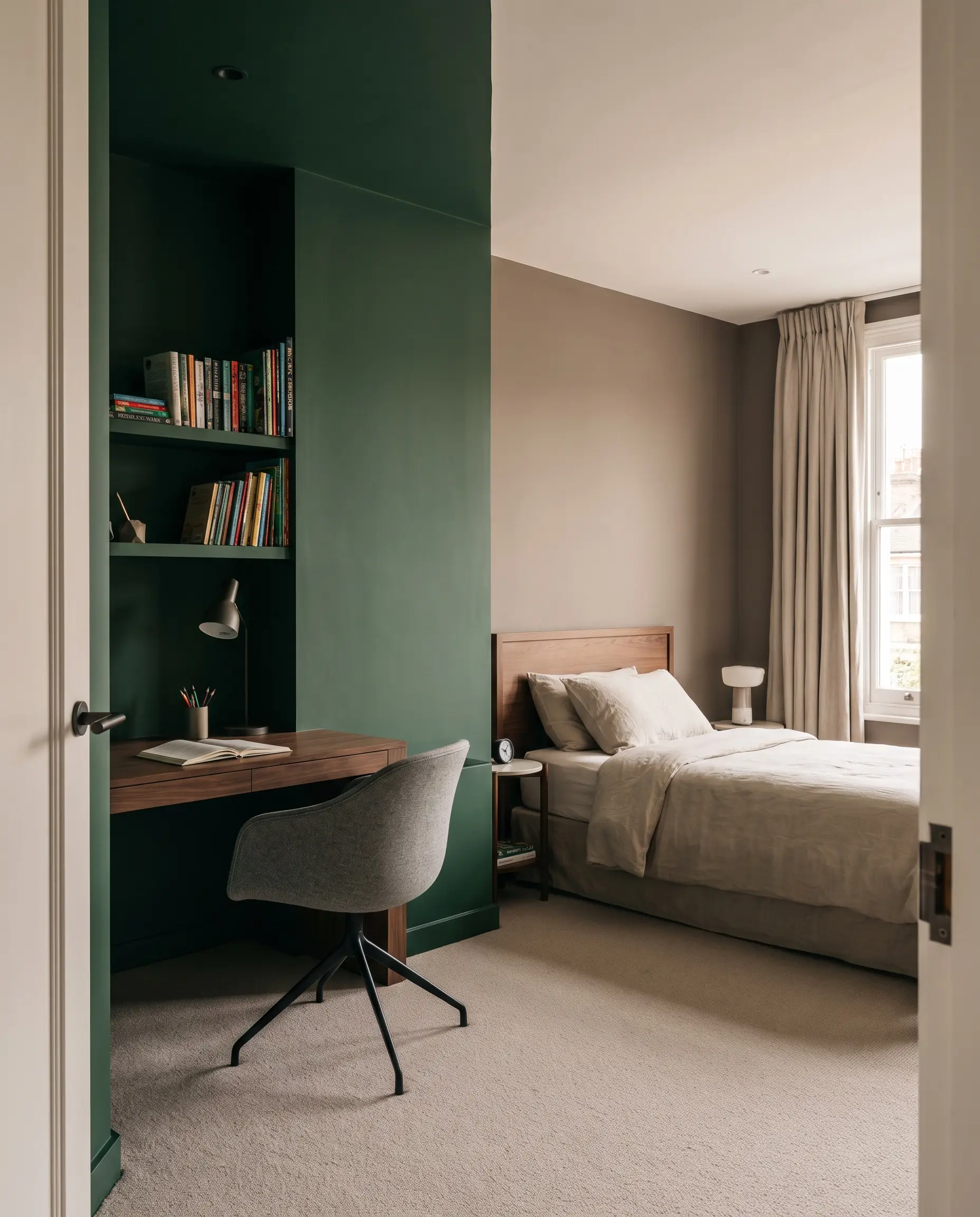 A crisp vertical color block in deep forest green defines a dedicated study zone featuring a sleek wooden desk against a warm mushroom wall.
