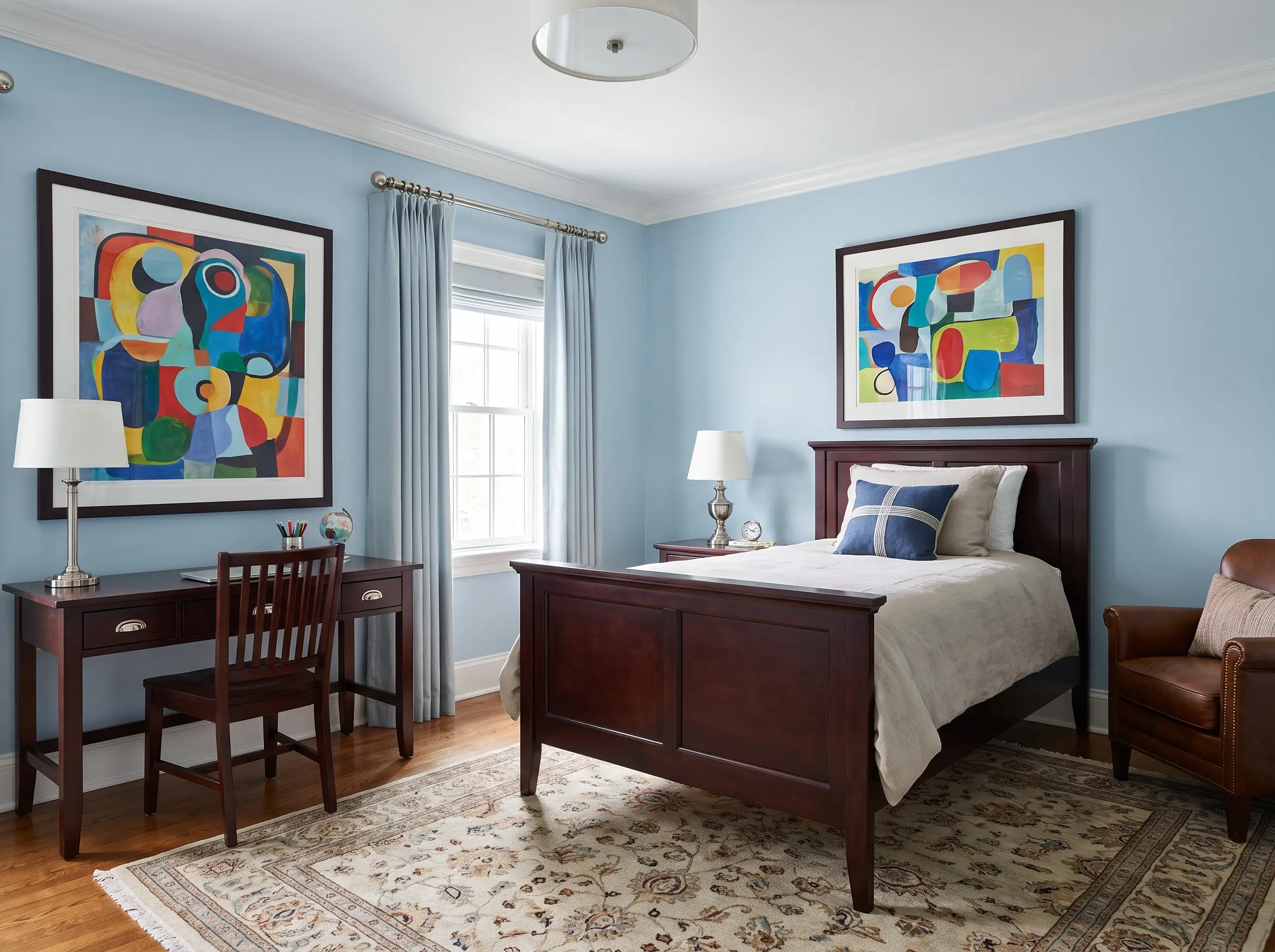 Benjamin Moore Sapphire Ice walls create an expansive backdrop for rich dark mahogany furniture, vibrant modern art, and polished nickel hardware.