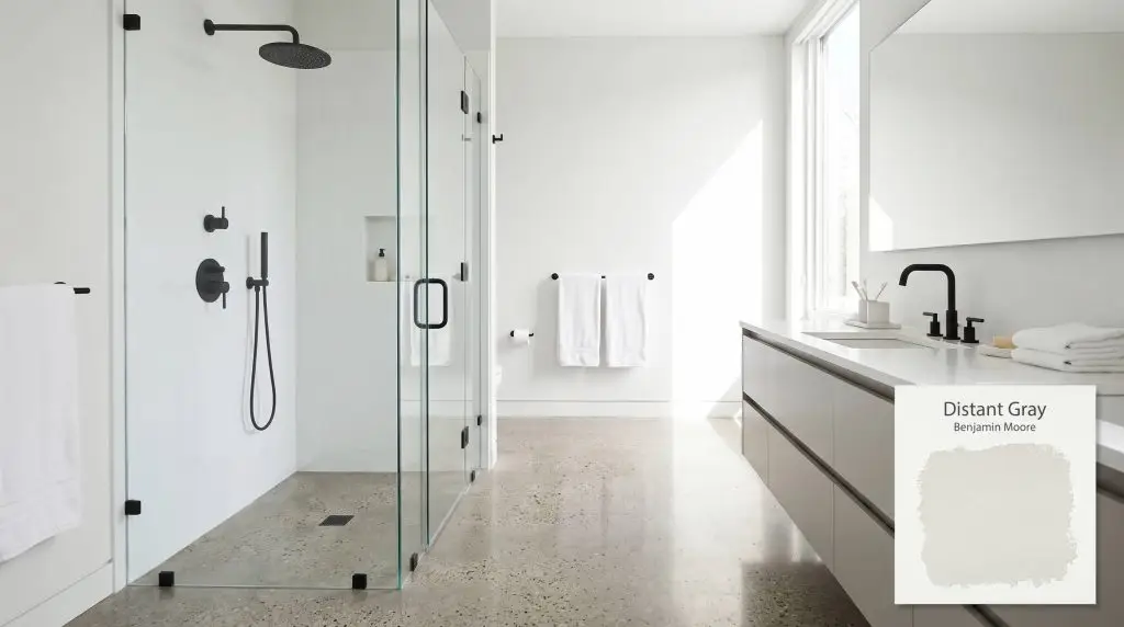 A frameless glass shower and matte black fixtures contrast with polished concrete floors and walls coated in Distant Gray (Hex #F2F4F1).