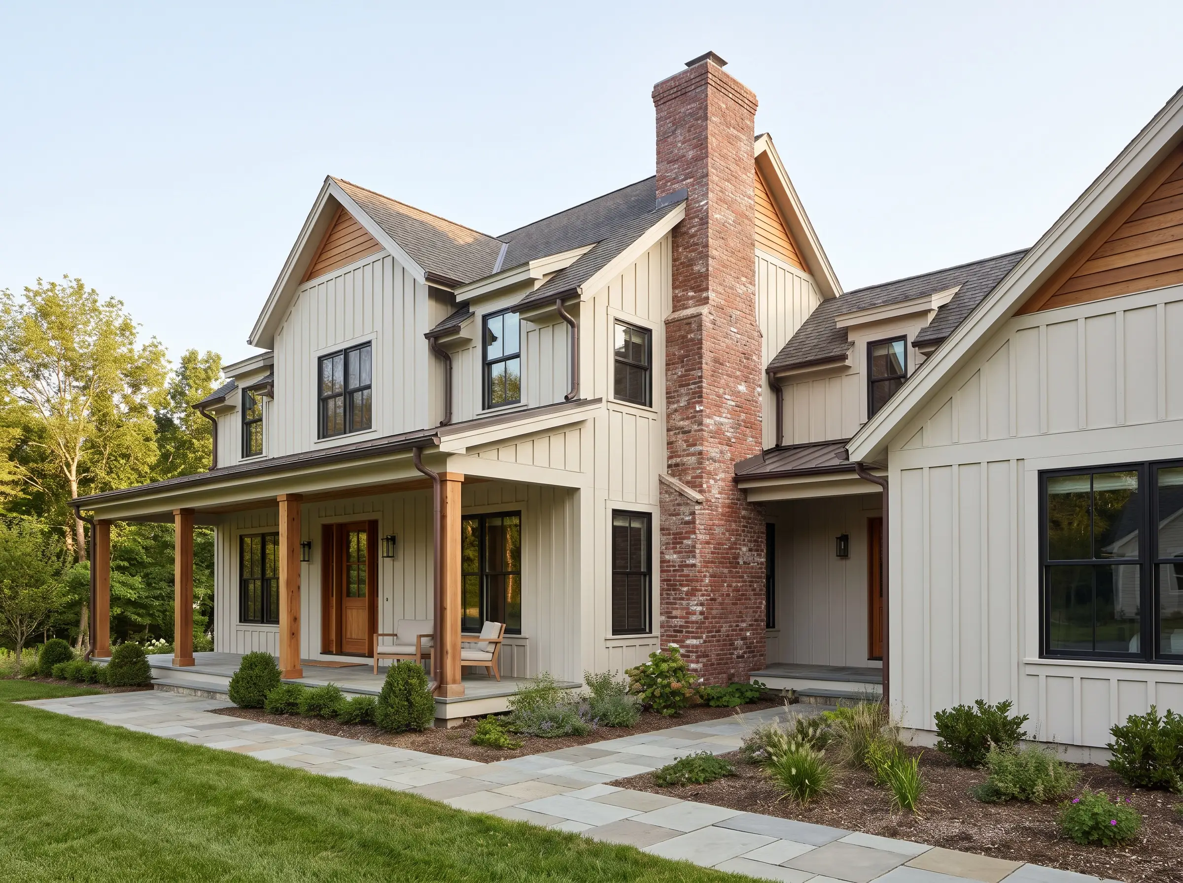 Black architectural windows and cedar wood accents complement Behr Campfire Ash siding, contrasting sharply against a massive traditional red brick chimney.
