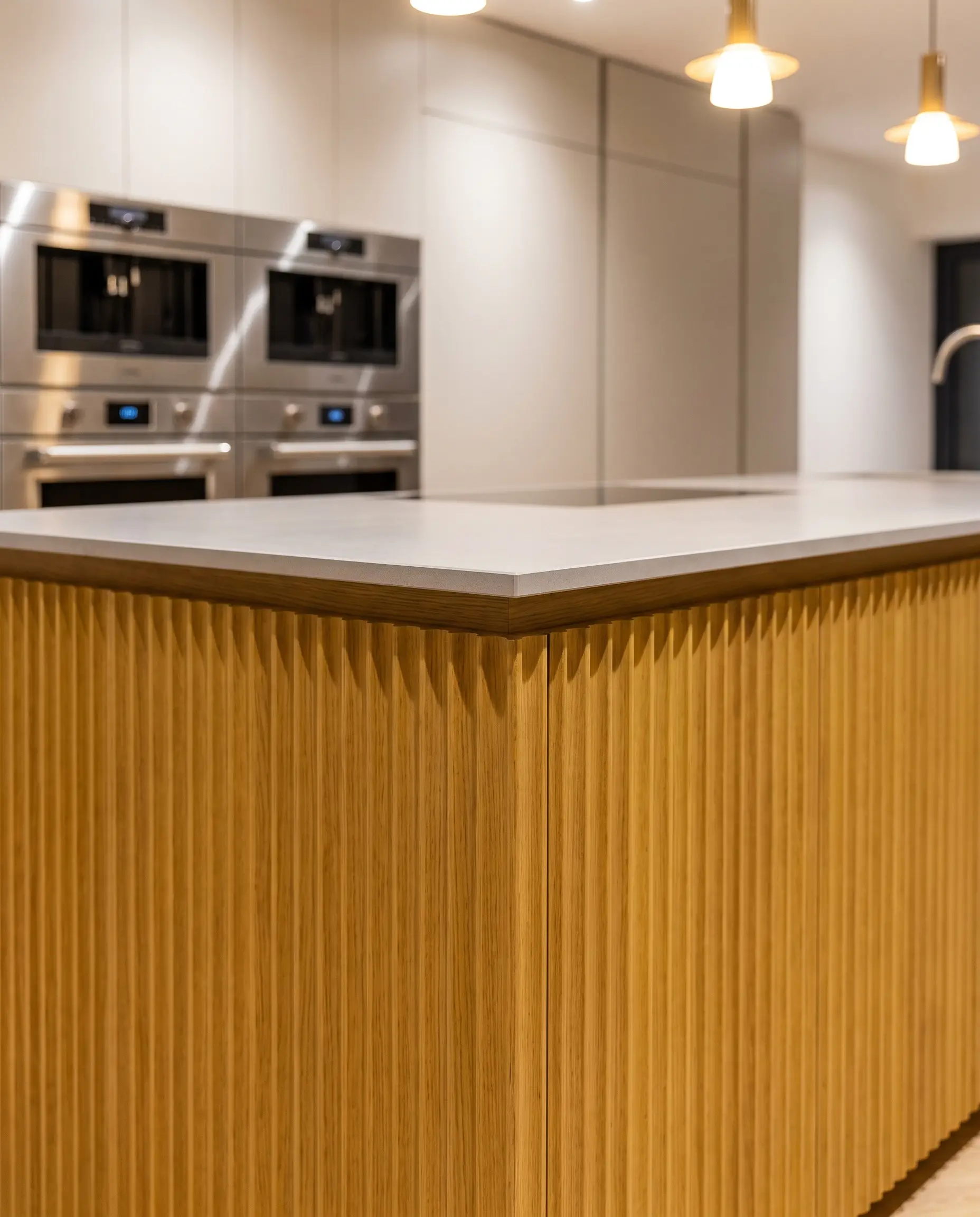 Custom fluted oak panels finished in a satin yellow lacquer wrap a contemporary island base beneath an ultra-thin flat-ease edge countertop.