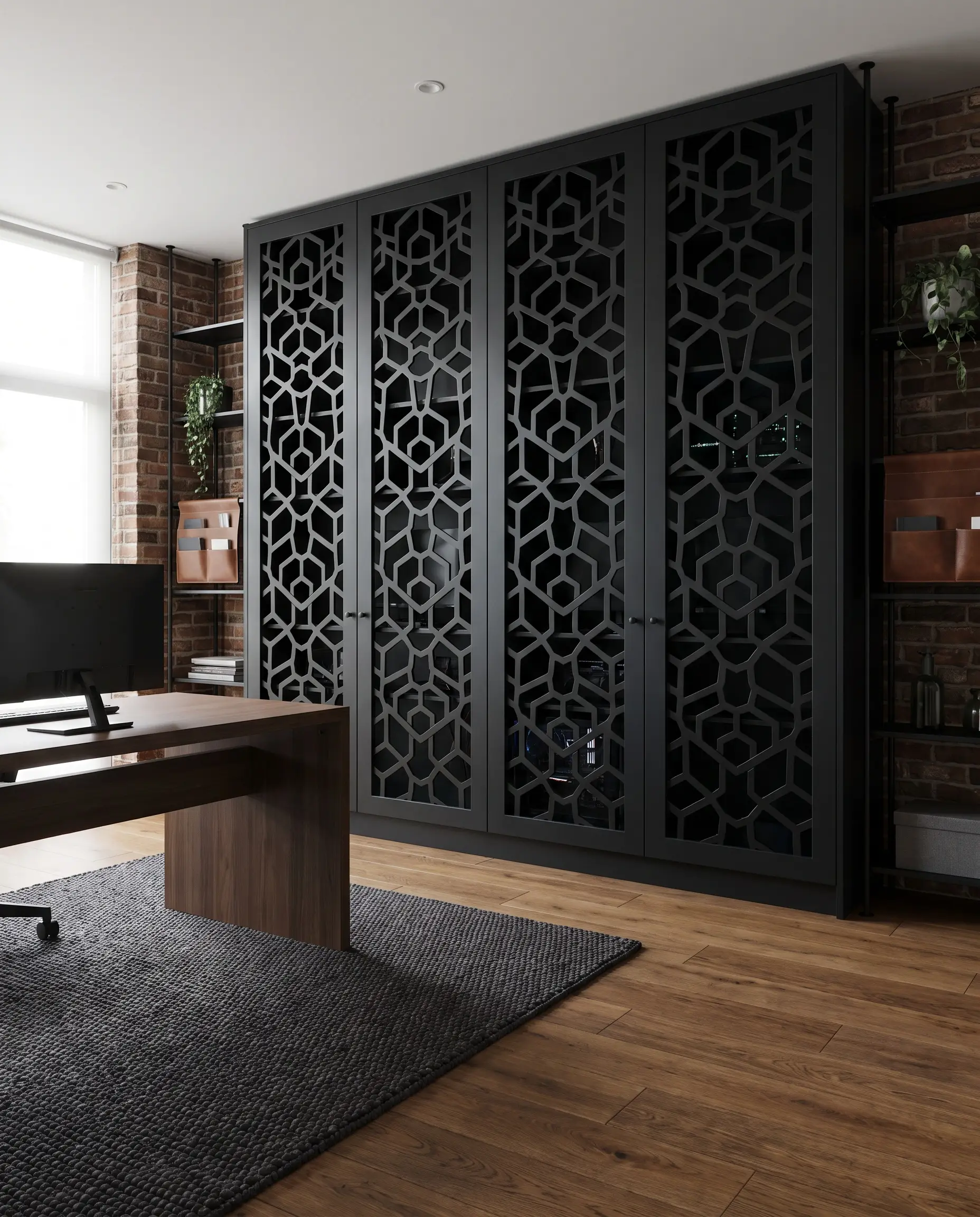 Custom built-in office cabinetry features solid matte black perforated MDF doors with geometric cutouts behind a sleek modern desk in an industrial chic workspace.