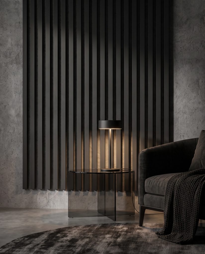 Razor-thin pine slats painted matte Tricorn Black mount over a textured grey microcement wall behind sleek smoked glass side tables and black fixtures.