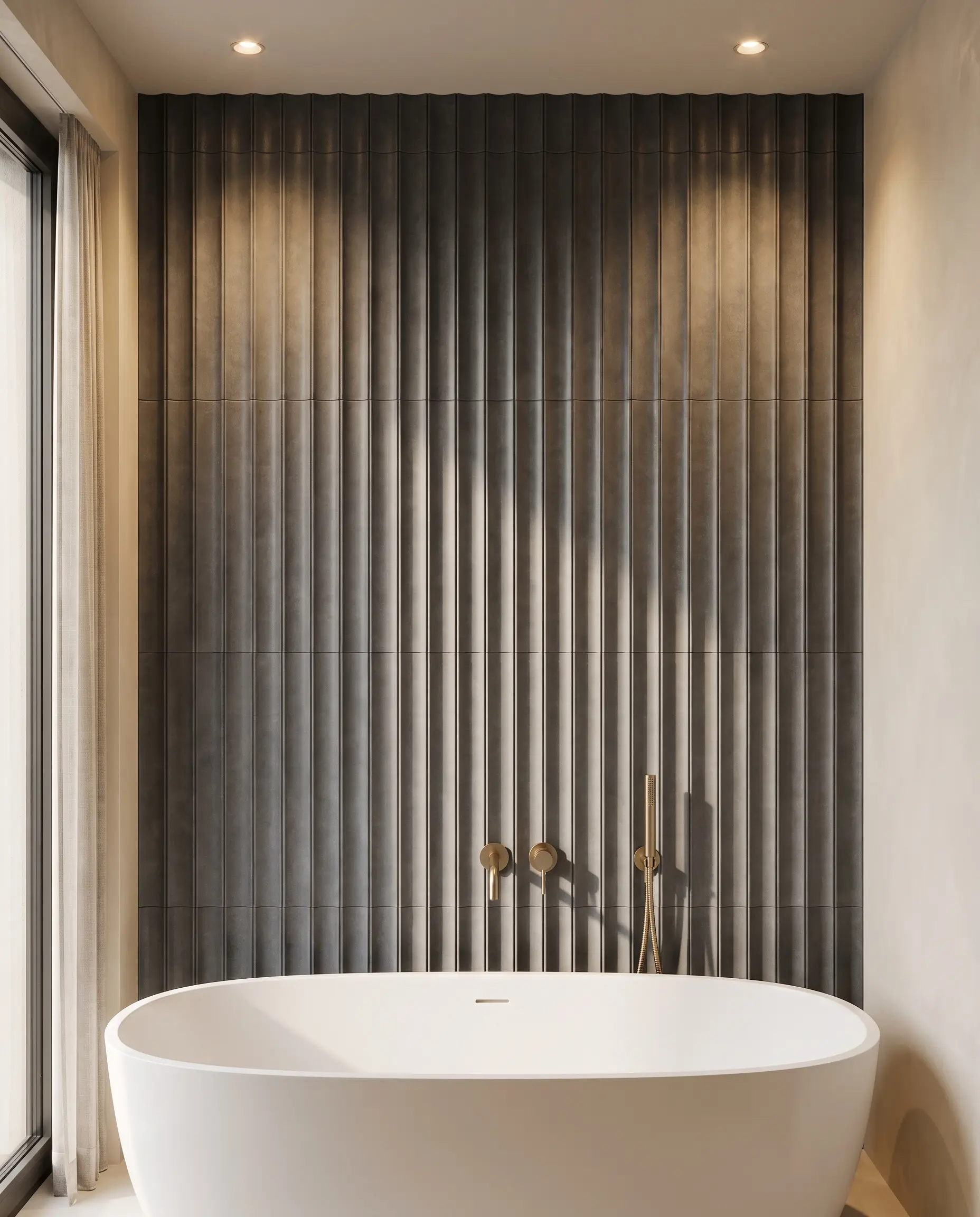 Large-format 3D fluted porcelain tiles with deep vertical ridges sit behind a contemporary white freestanding bathtub, highlighting tactile bathroom wall covering trends 2027.