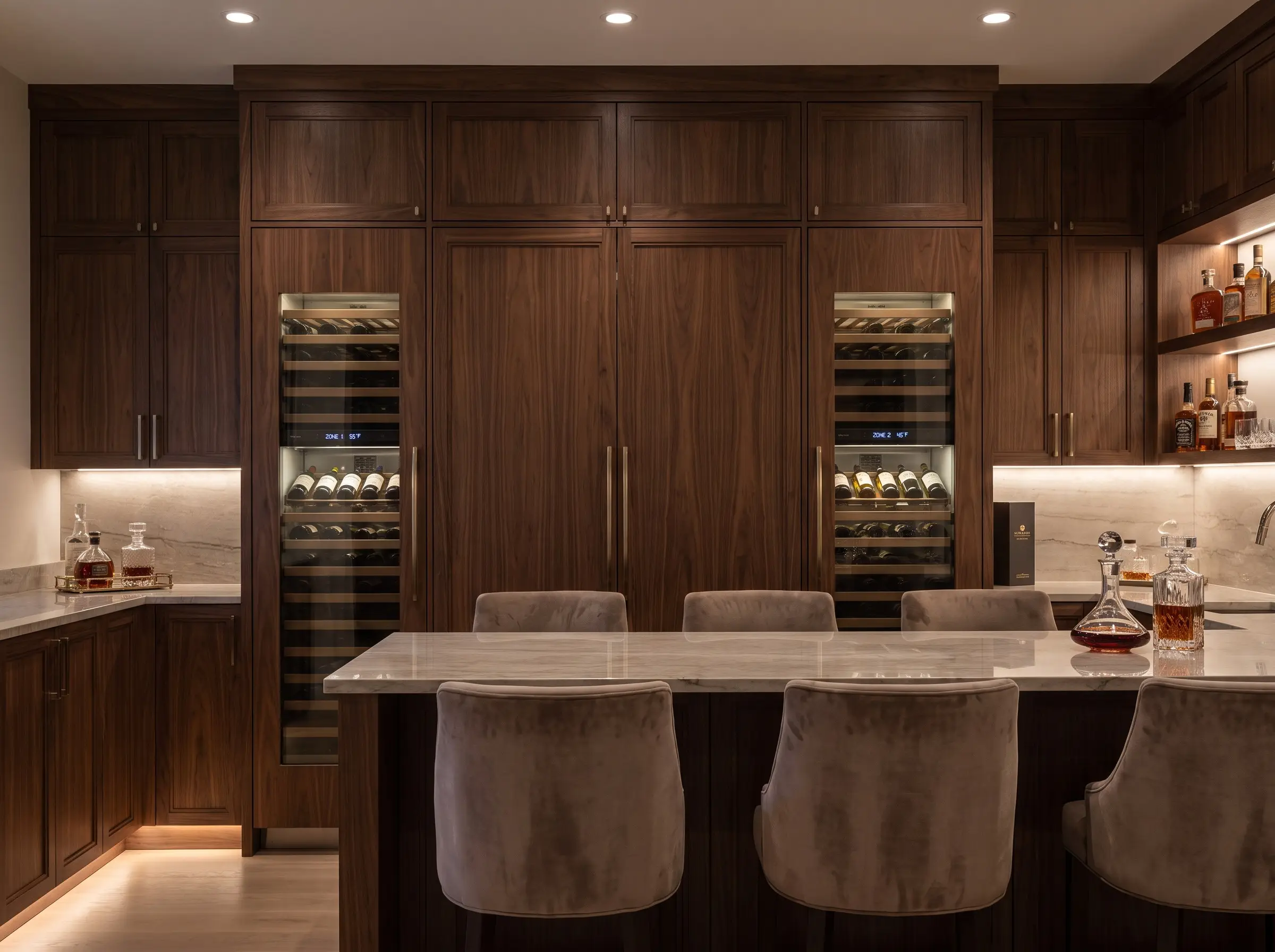 Panel-ready dual-zone climate control wine columns sit perfectly flush with custom millwork, highlighting modern home bar and wine storage trends alongside a tasting counter.