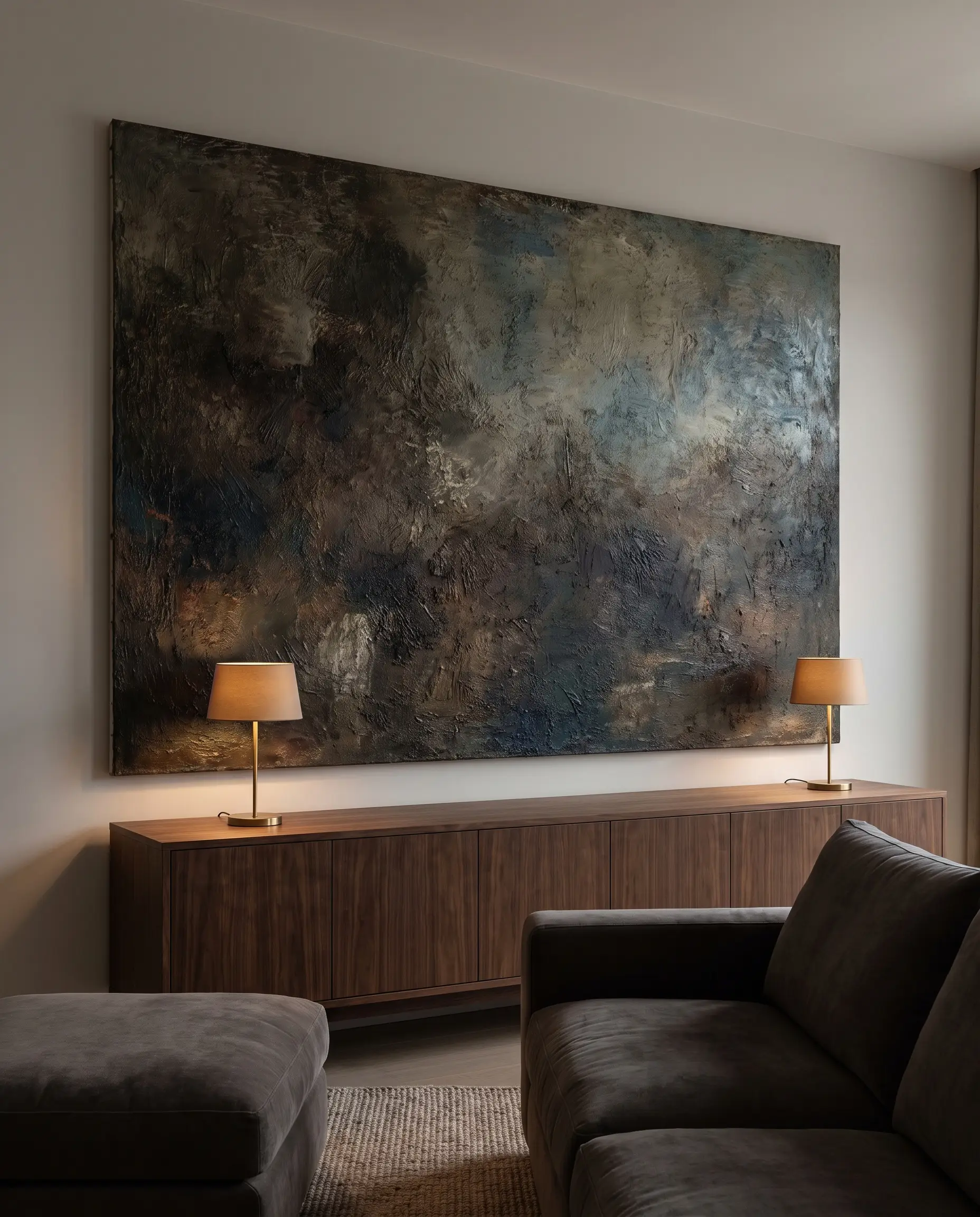 A commanding deeply textured canvas hangs above a dark walnut credenza, highlighting living room design trends focused on singular oversized statement art.